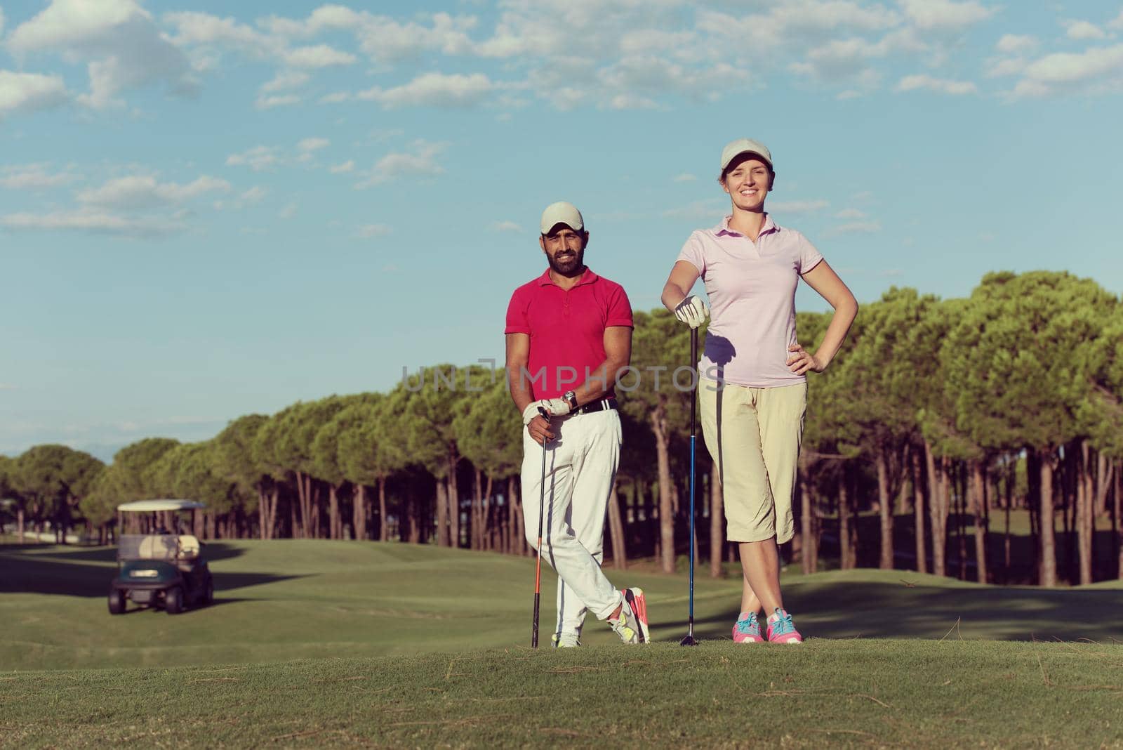 portrait of happy young  couple on golf course