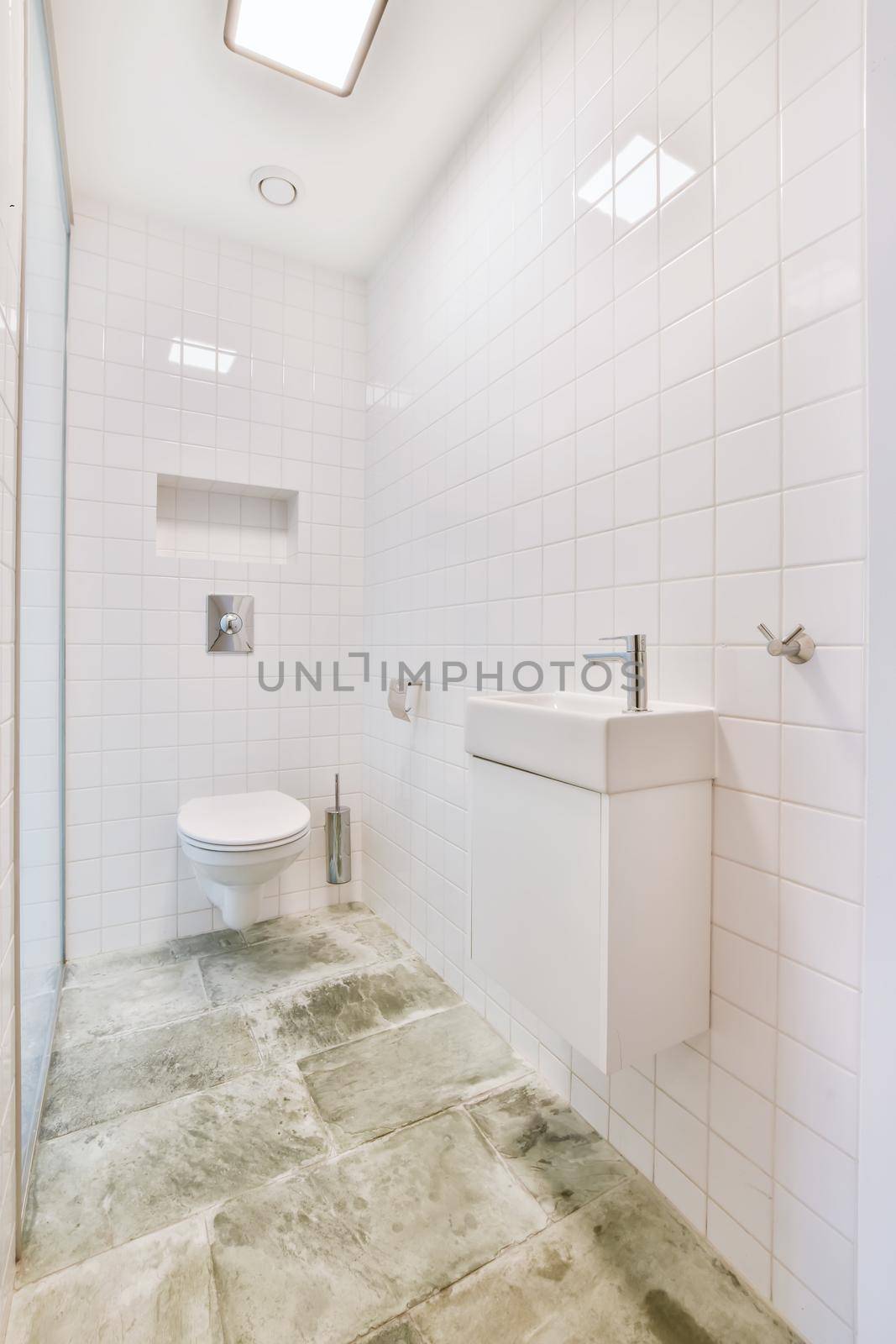 Brightly lit elongated washroom with marble floor