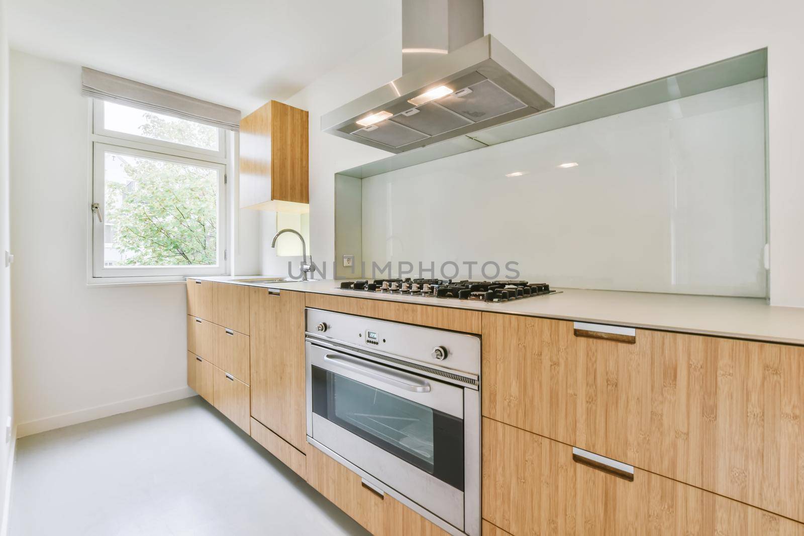 Long kitchen area with wooden kitchen unit