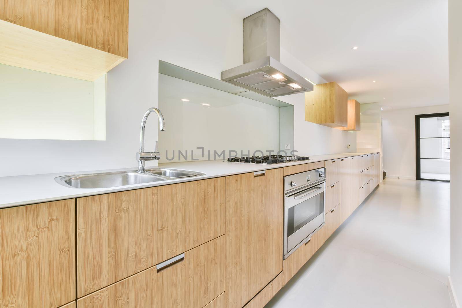 Long kitchen area with wooden kitchen unit