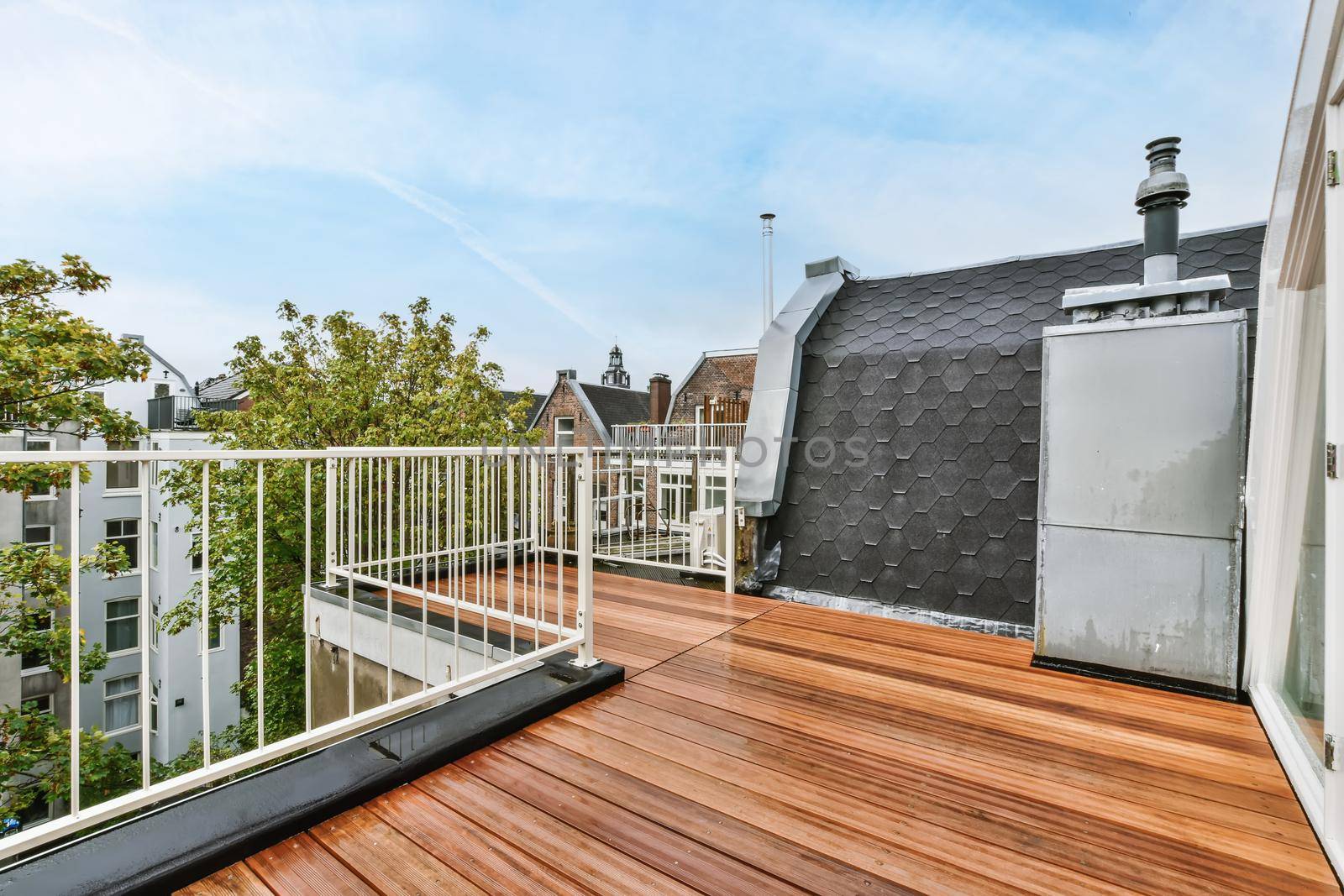 Rooftop exterior with delightful wood flooring and white railings