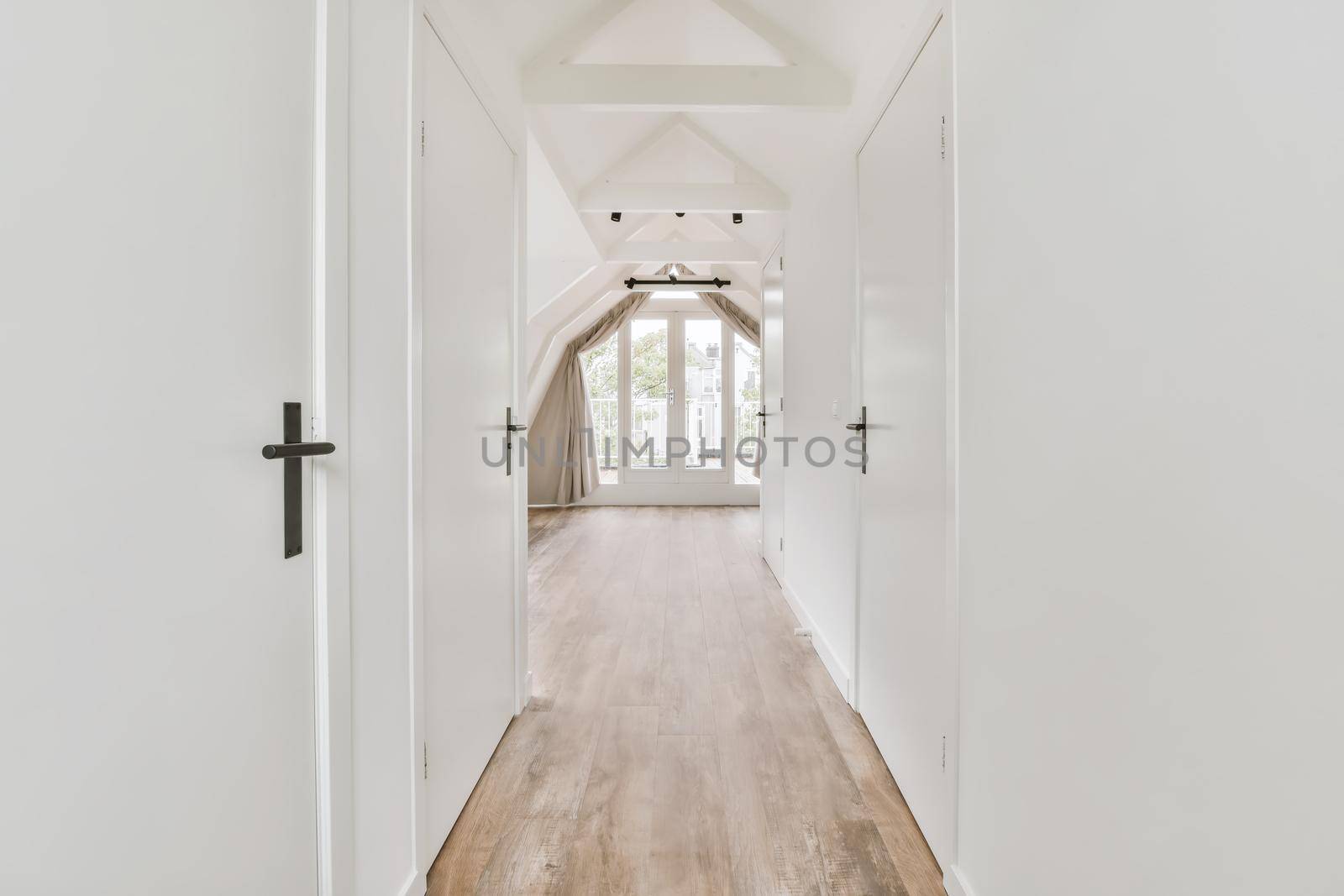 Stunning hallway with dark parquet floors and white walls