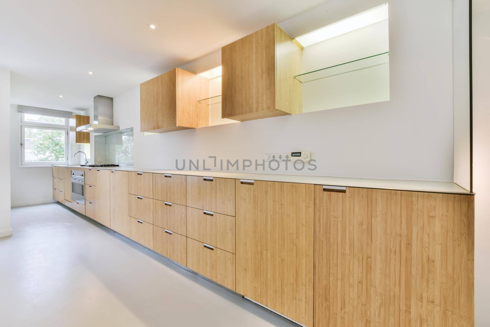 Long kitchen area with wooden kitchen unit