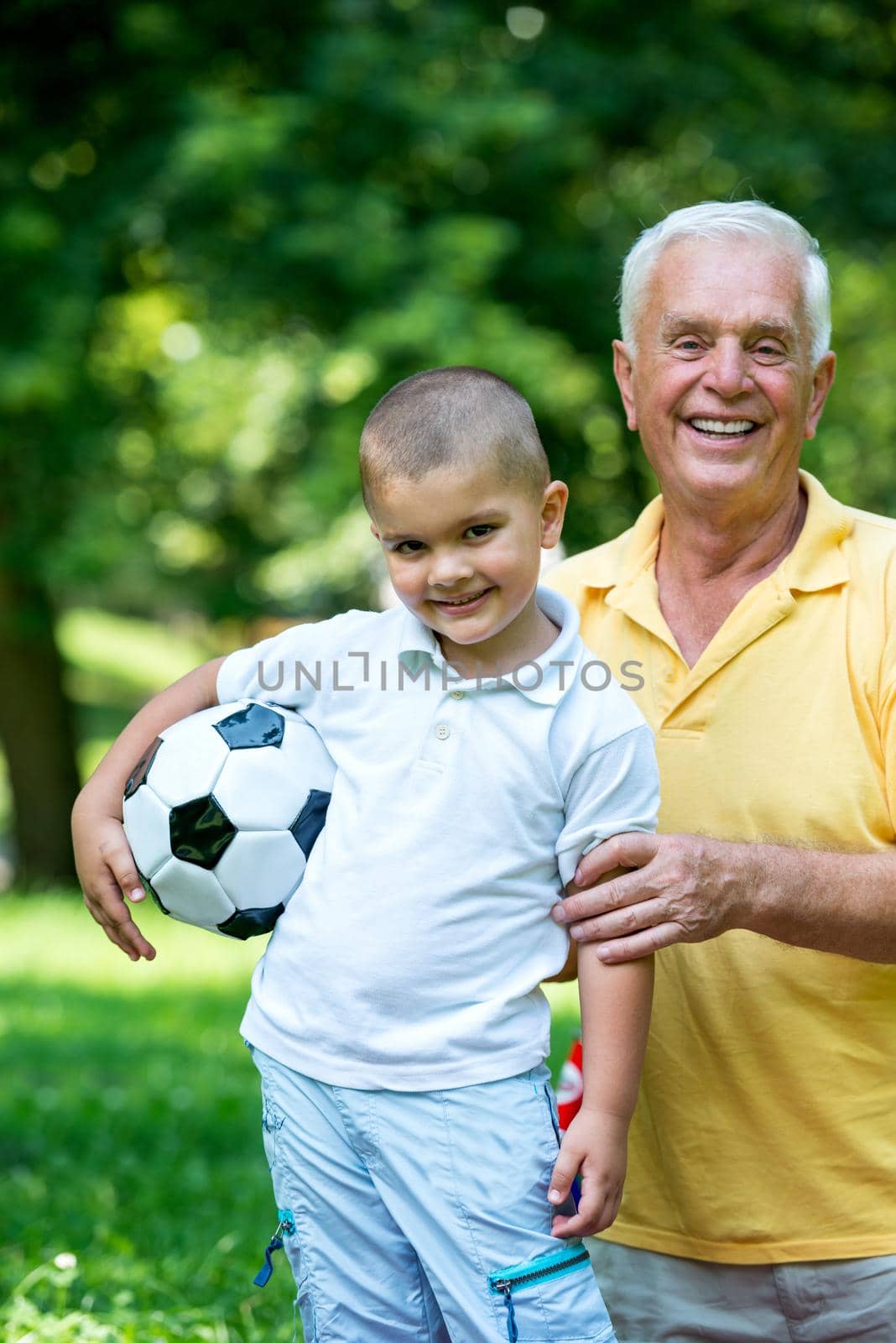 grandfather and child have fun  in park by dotshock