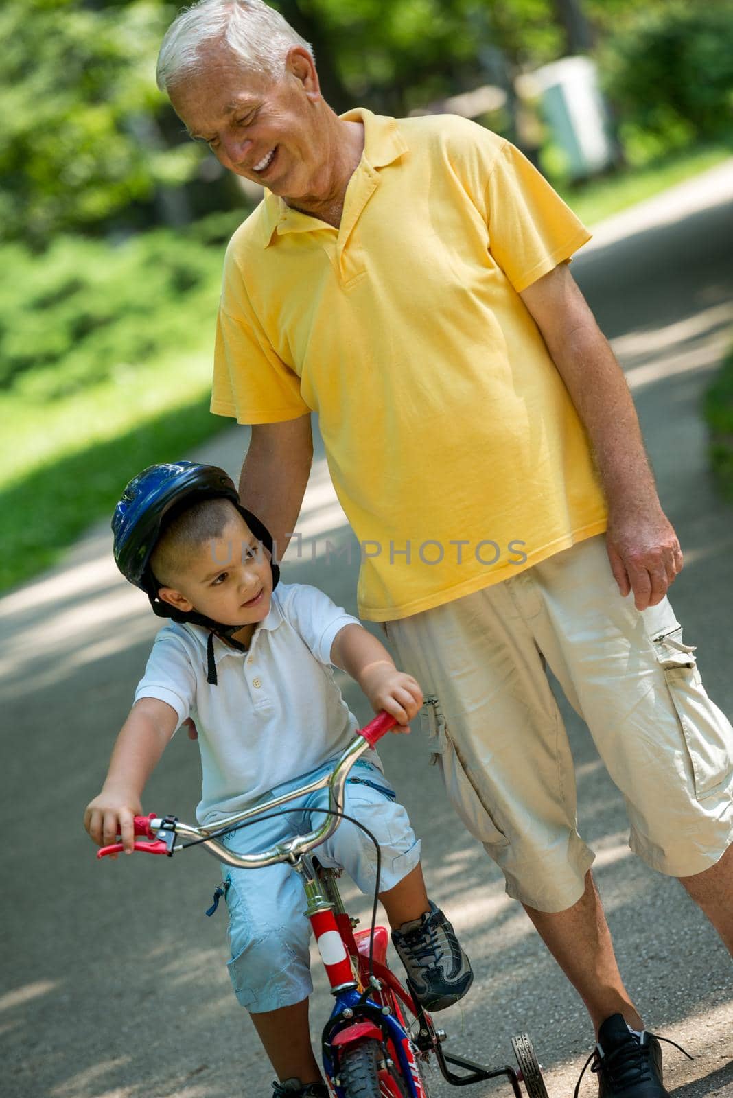 grandfather and child have fun  in park by dotshock