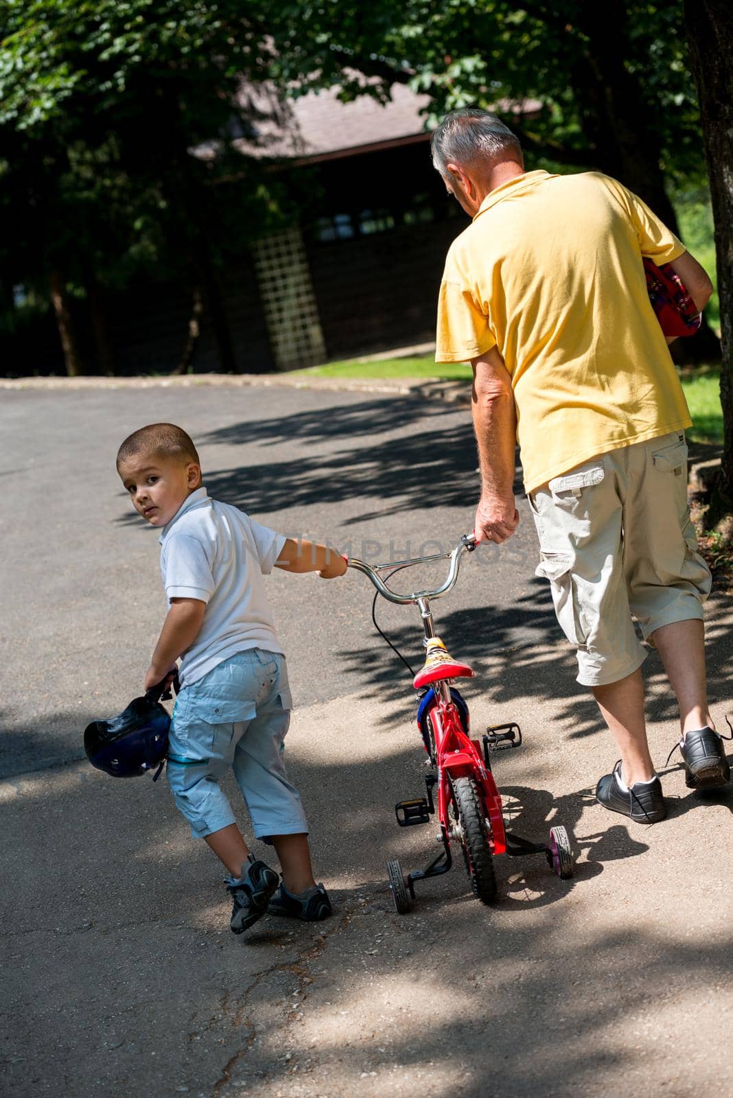 happy grandfather and child have fun and play in park on beautiful  sunny day