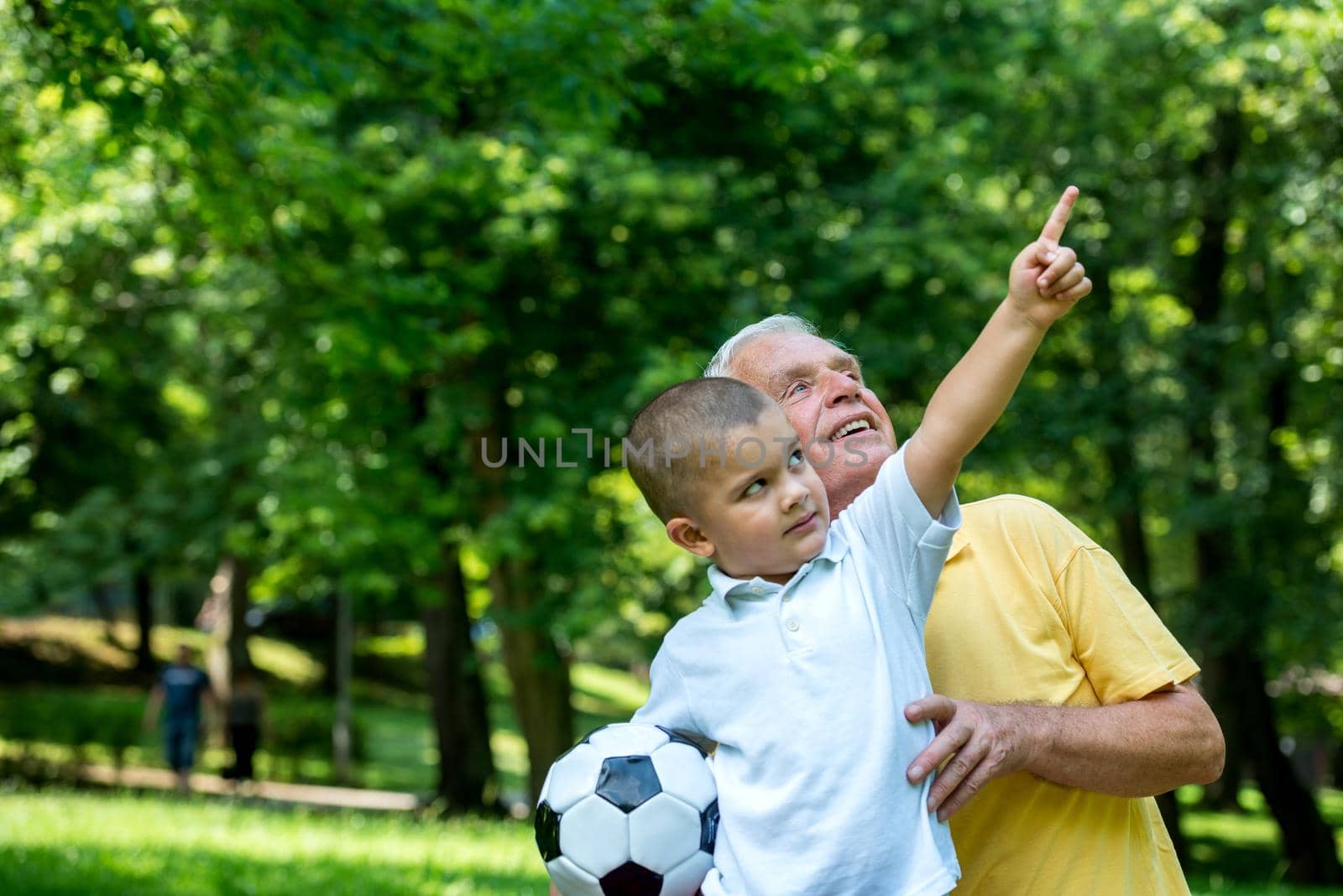 grandfather and child have fun  in park by dotshock