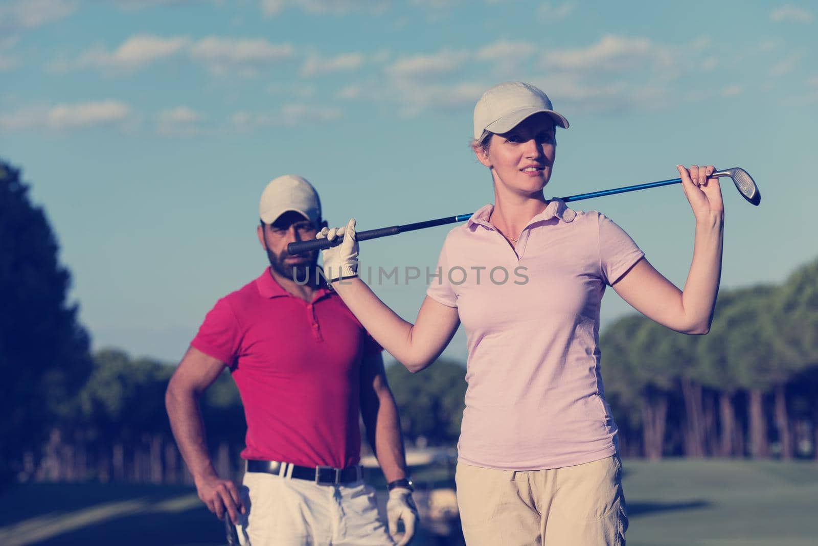 portrait of couple on golf course by dotshock