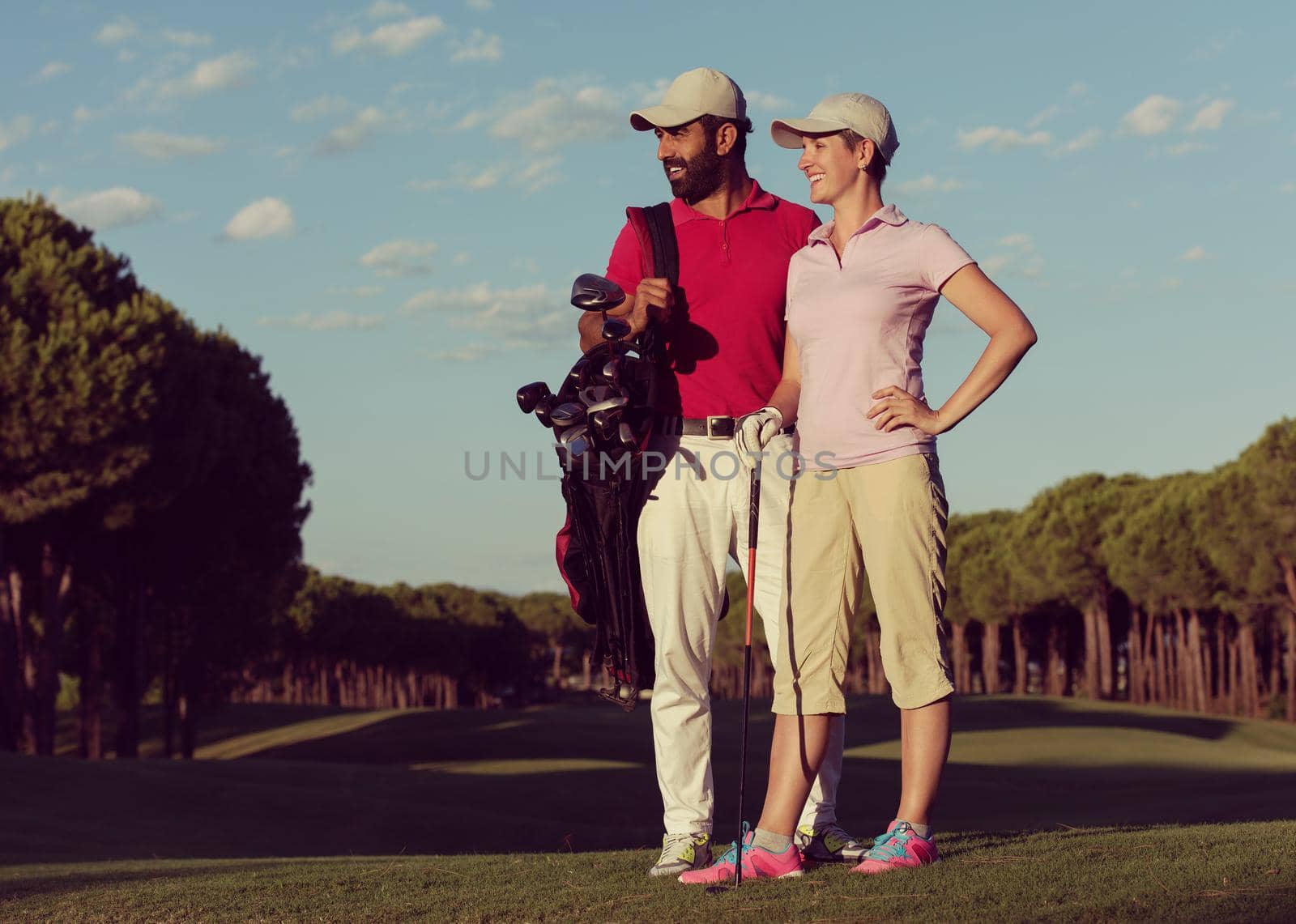 portrait of happy young  couple on golf course