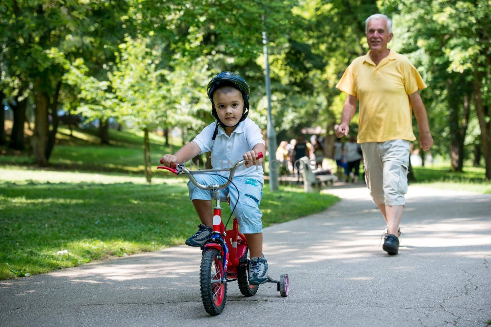 happy grandfather and child have fun and play in park on beautiful  sunny day