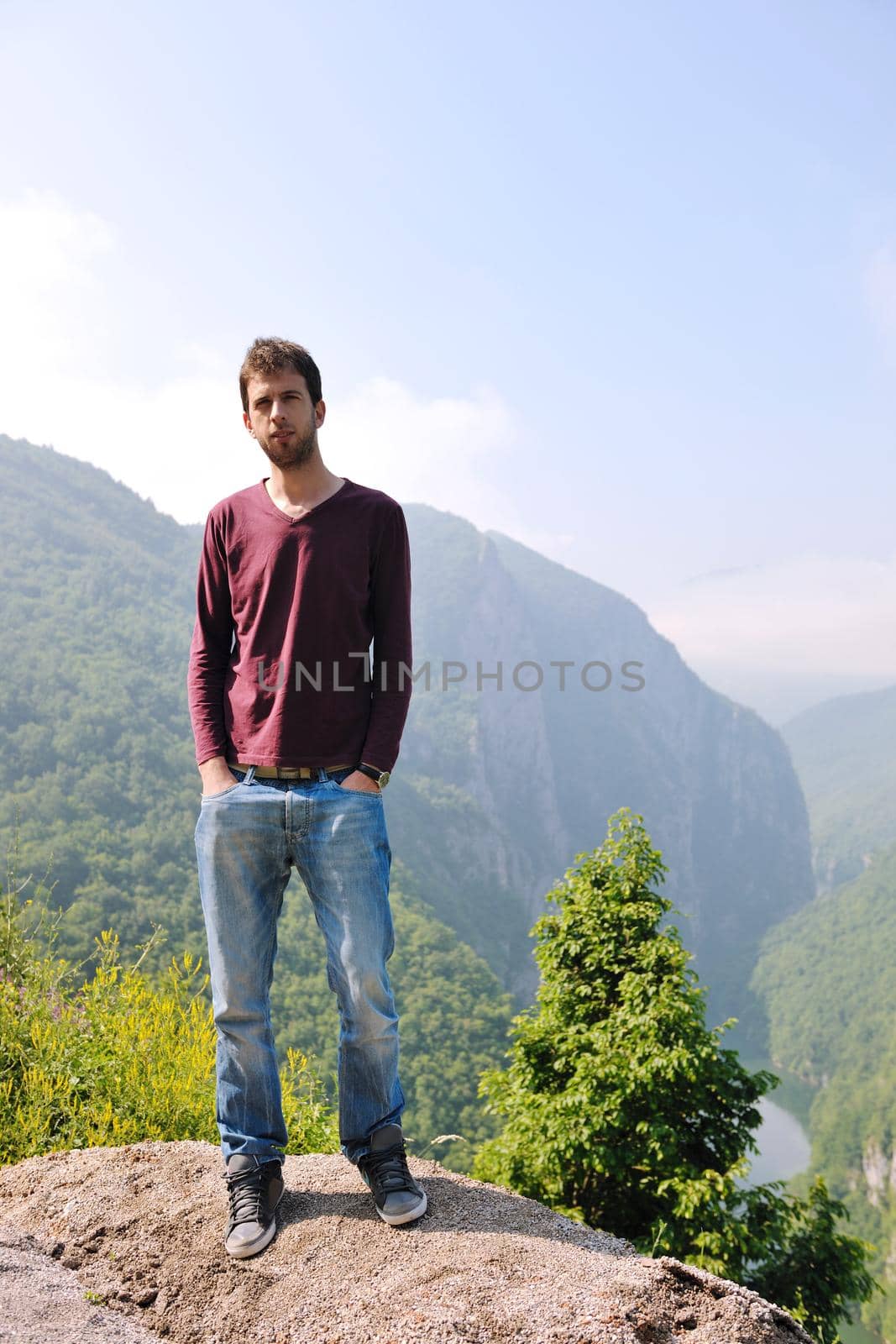 happy young man jump in nature while representing healthy lifestyle freedom and active concept