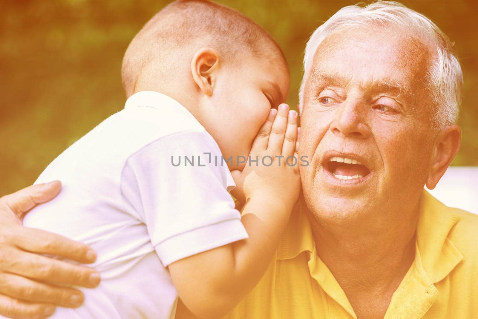 happy grandfather and child have fun and play in park on beautiful  sunny day