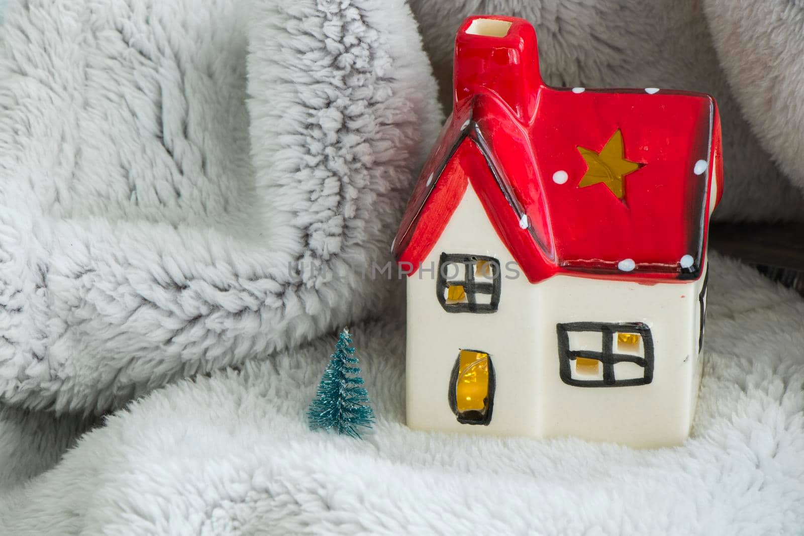 Toy house with red roof, pine tree and snow. New year decoration. Christmas spirit.