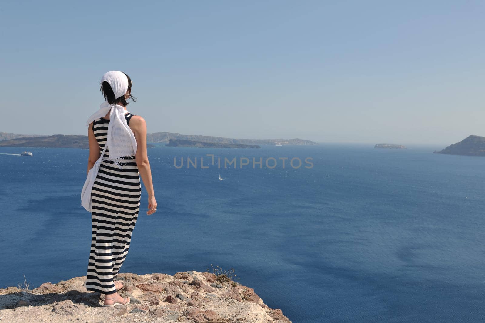 Greek woman on the streets of Oia, Santorini, Greece by dotshock