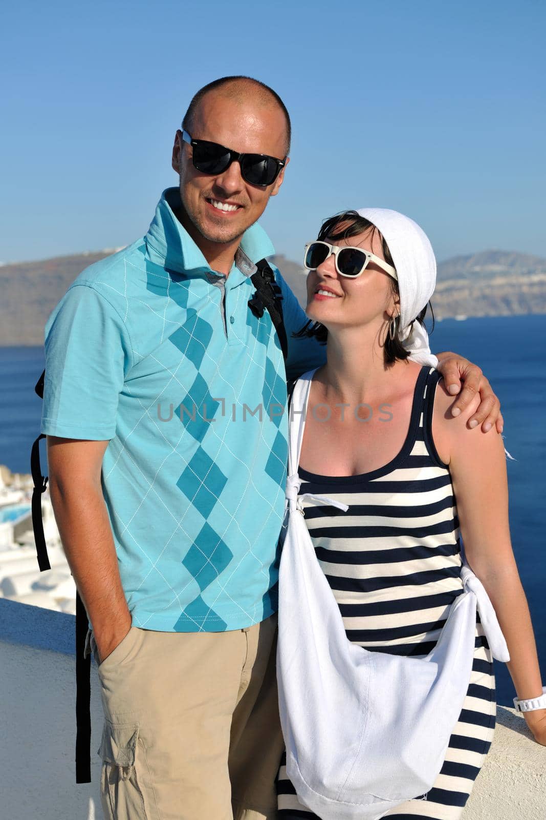 young couple portrait in love have romantic time on summer vacation holidays in greece santorini