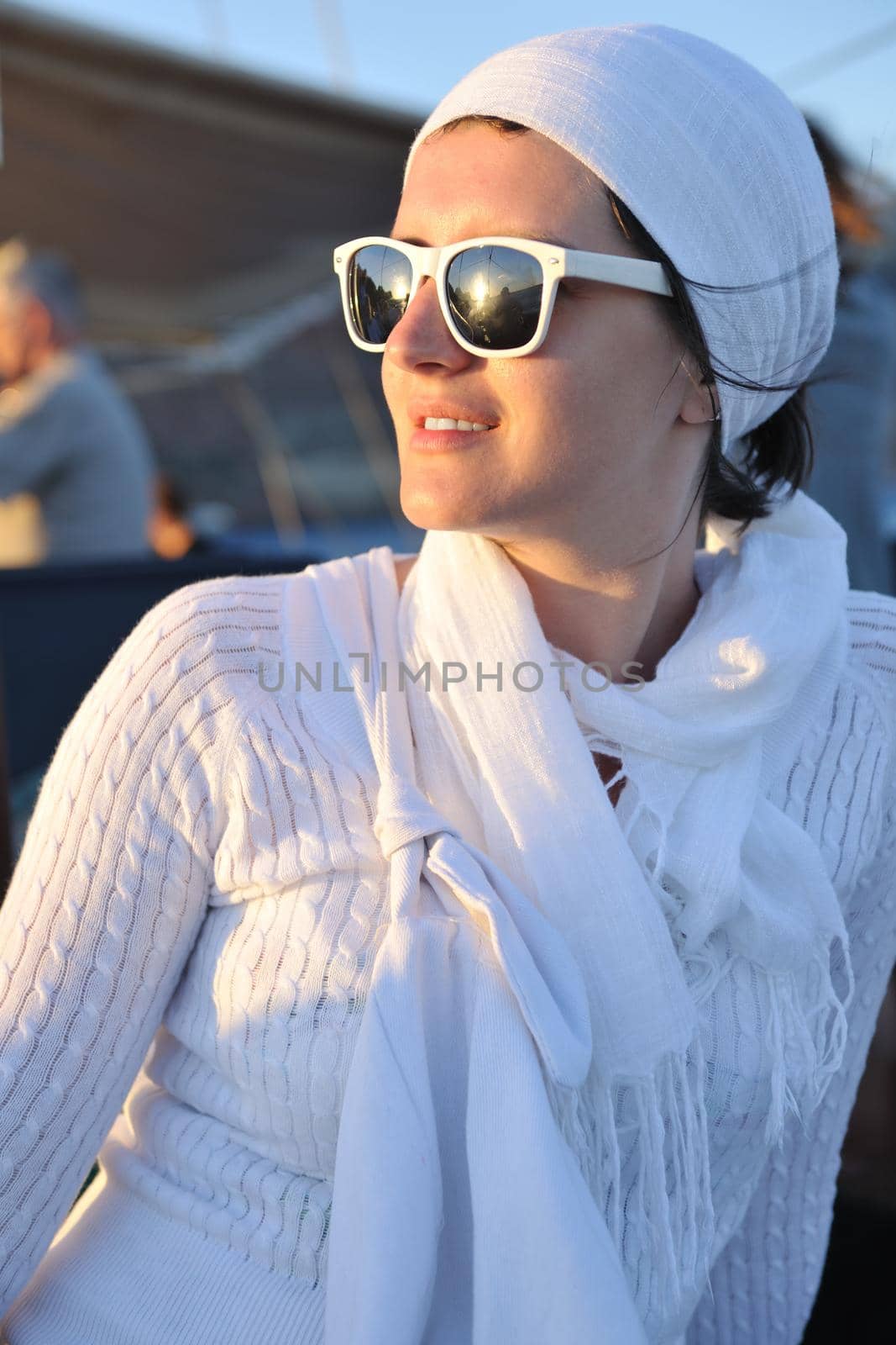 Beautiful young Greek woman in fashion clothes have fun at n the streets of Oia, Santorini, Greece