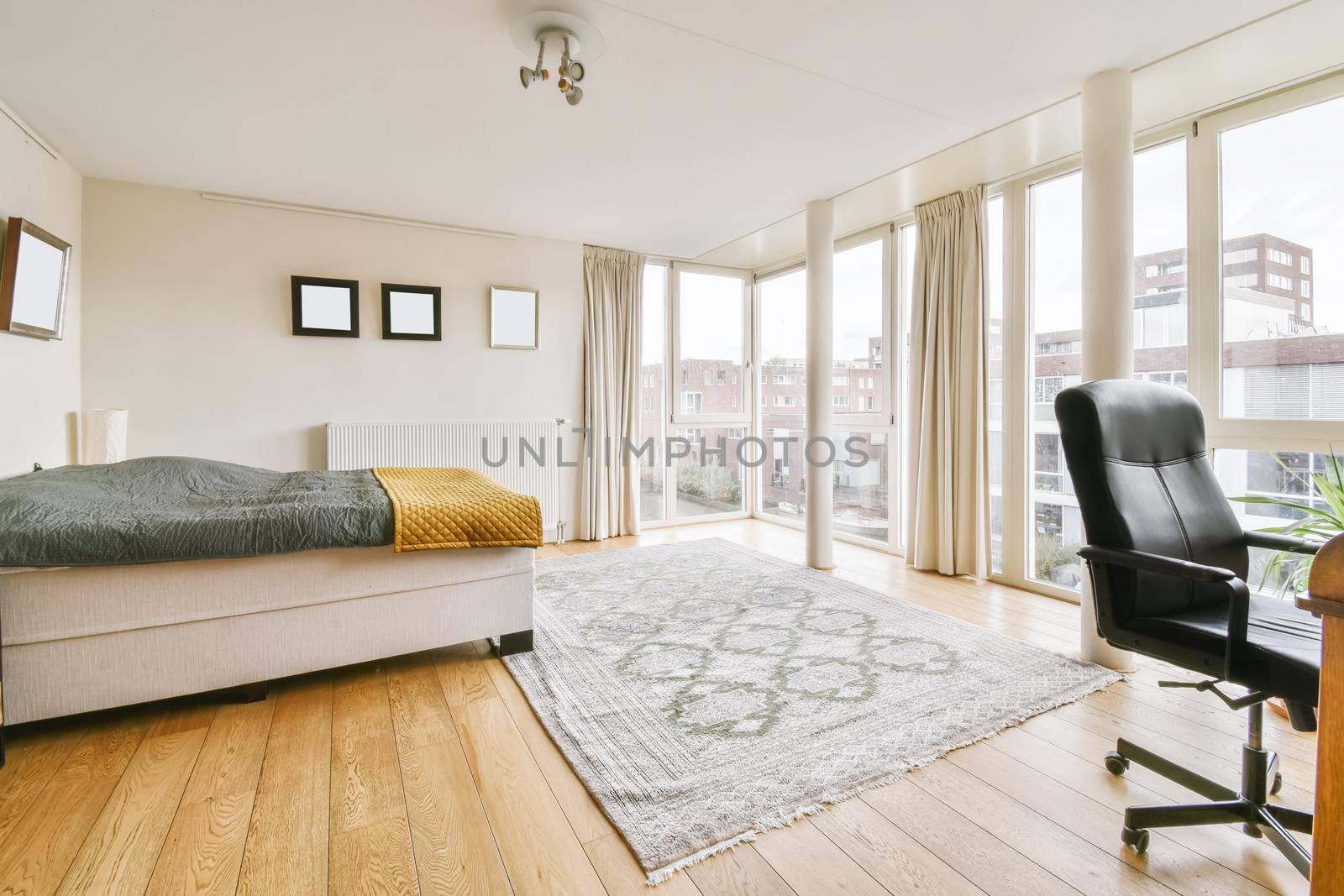 Lovely bedroom with a large bed and a black leather chair