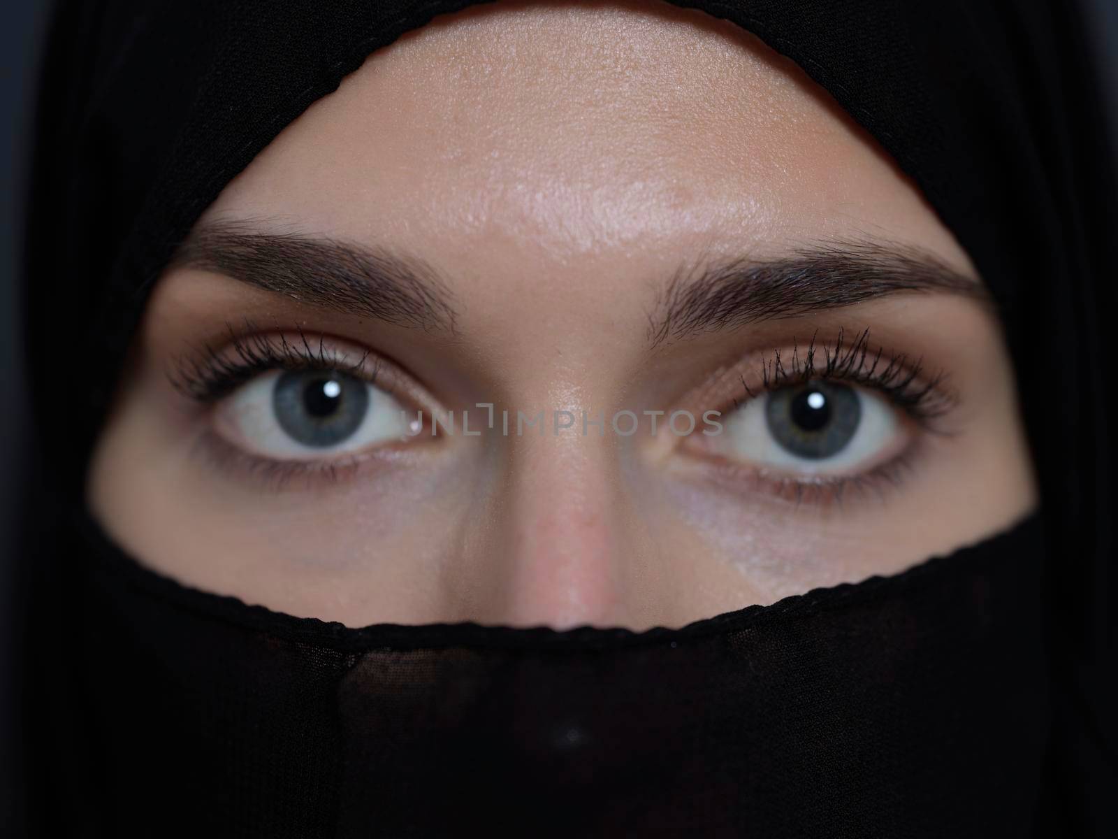 Portrait of muslim woman wearing niqab and traditional arabic clothes or abaya. Arab woman representing modern arabic lifestyle, islamic  fashion and Ramadan kareem concept