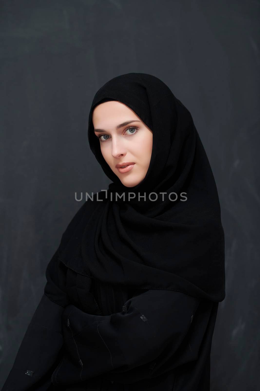 Modern young muslim woman in black abaya by dotshock