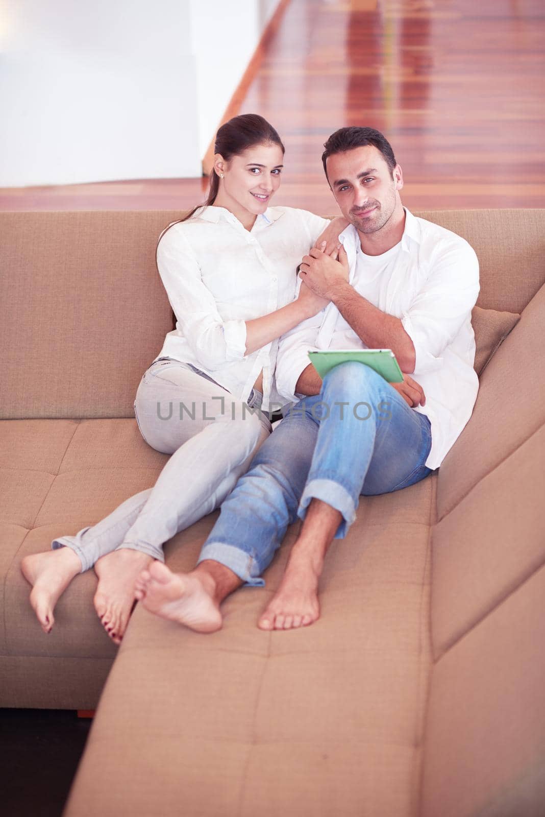 romantic relaxed young couple at modern home using tablet computer