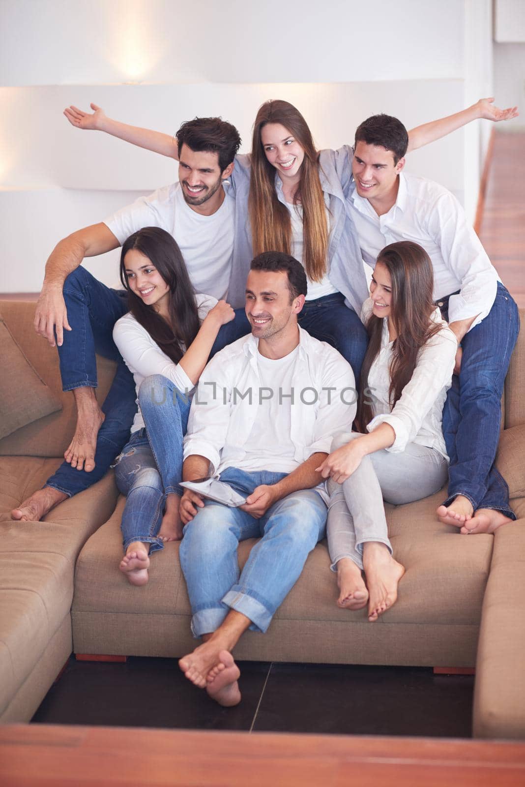 group of friends taking selfie photo with tablet at modern home indoors