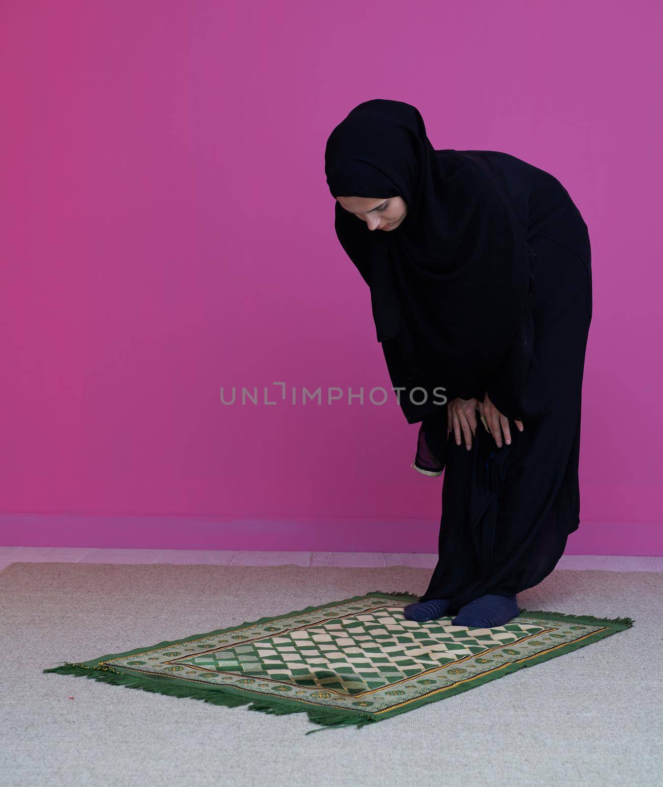 Muslim woman in namaz praying for Allah muslim god. Muslim woman on the carpet praying in traditional middle eastern clothes, Woman in Hijab