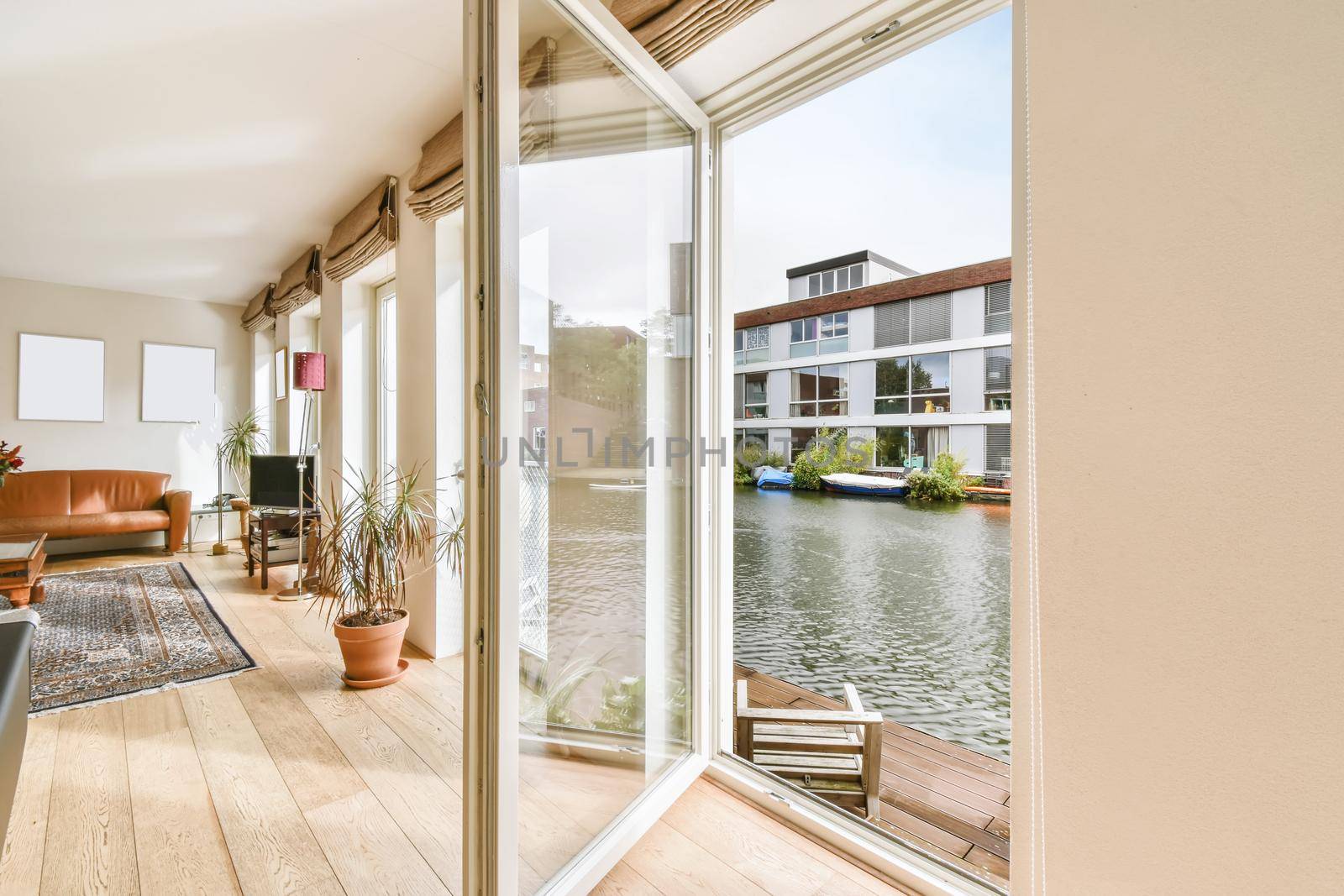 Lovely living room with an open door overlooking the boathouse