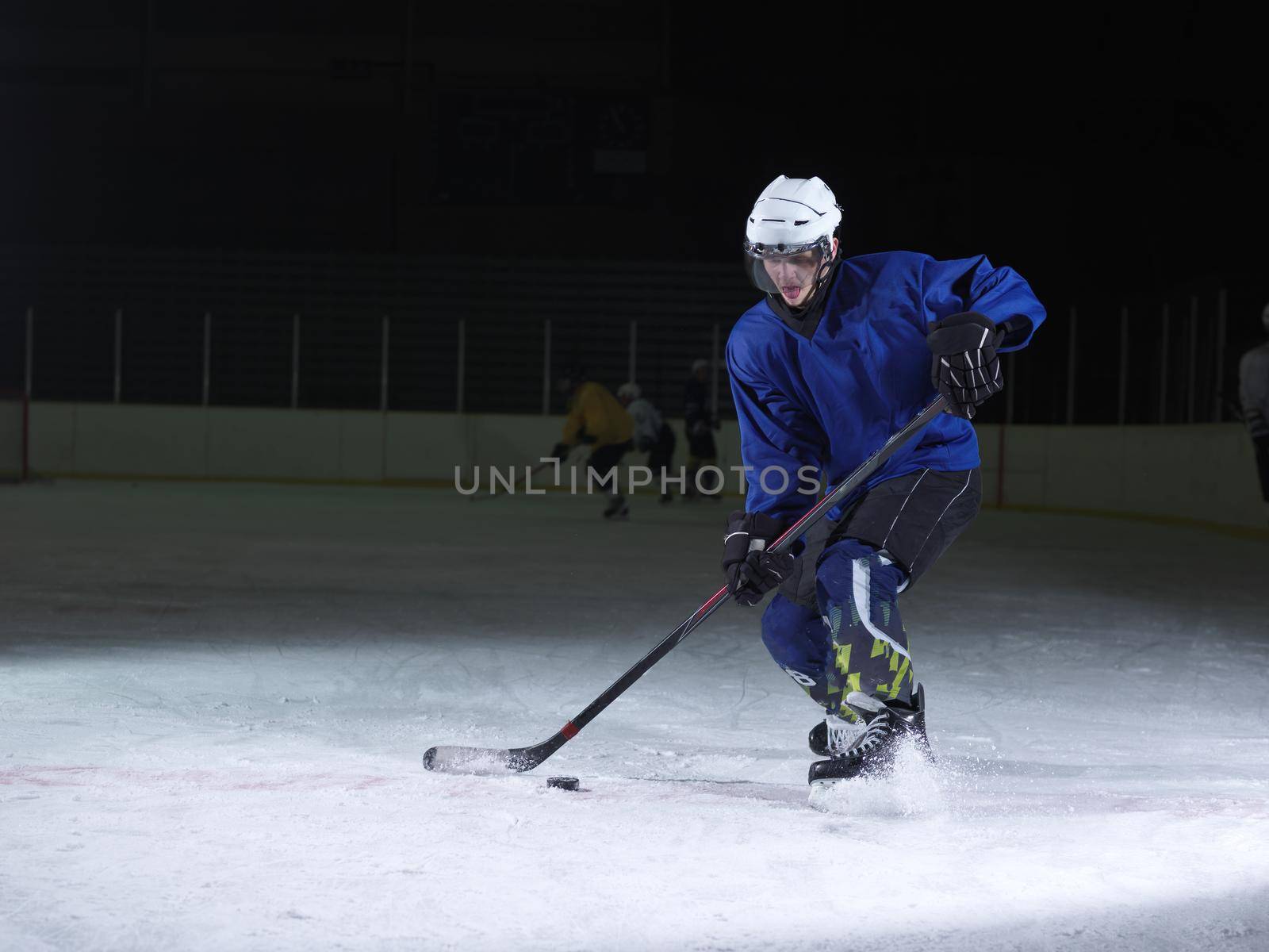 ice hockey player in action kicking with stick