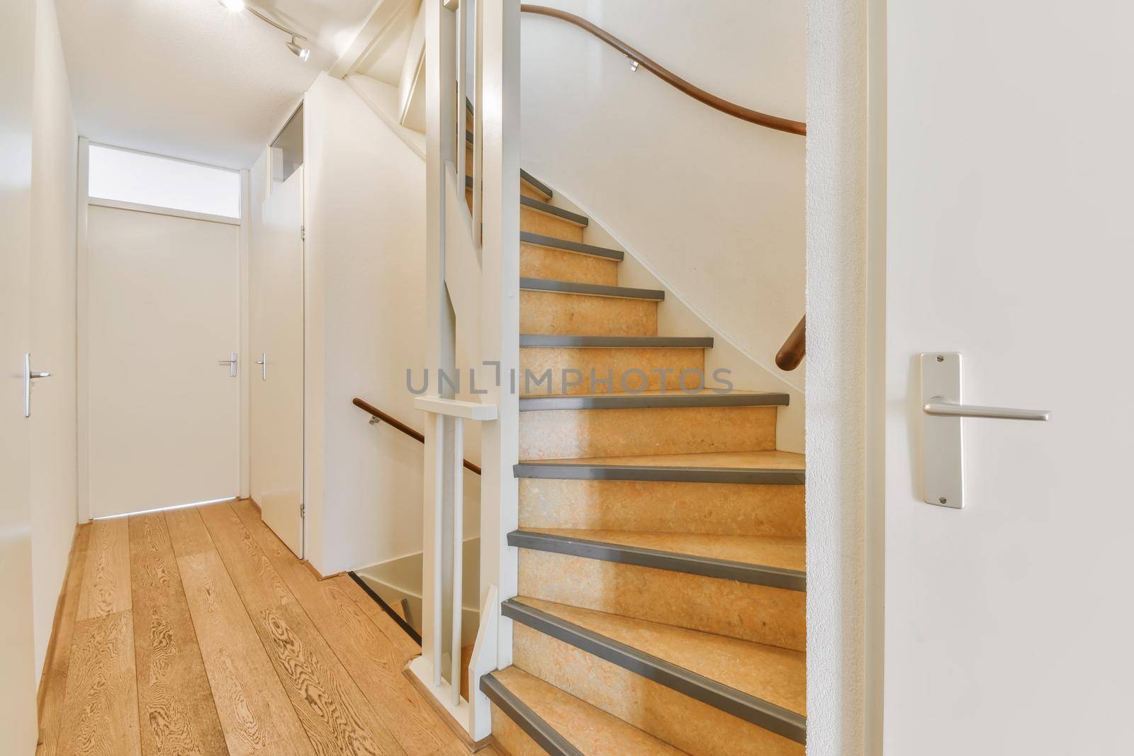 Lovely corridor with wooden floor and spiral staircase