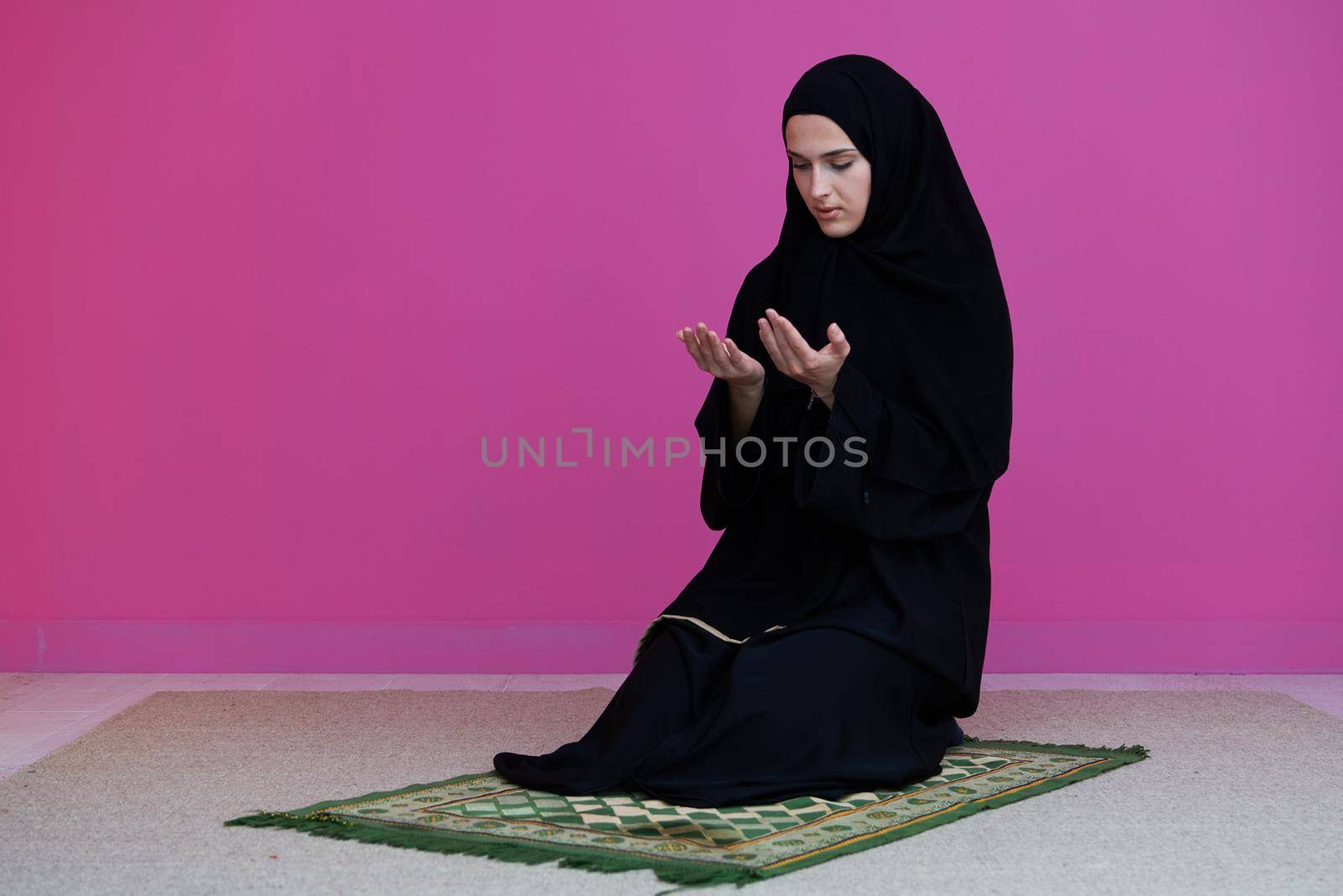 Muslim woman in namaz praying for Allah muslim god. Muslim woman on the carpet praying in traditional middle eastern clothes, Woman in Hijab