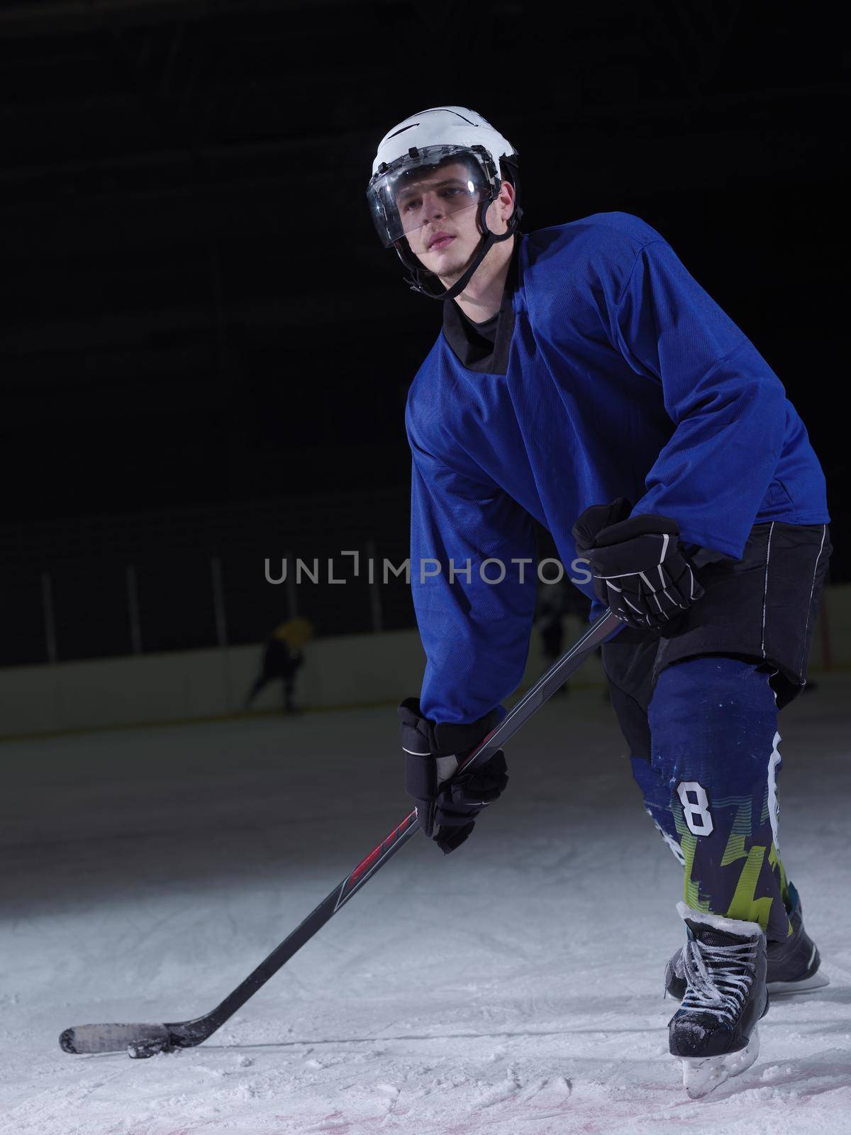 ice hockey player in action kicking with stick