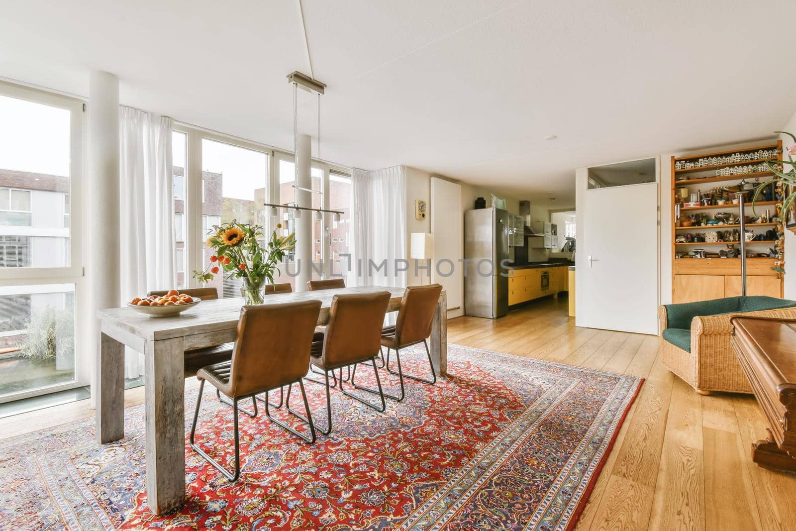 Lovely expansive dining area with large table and large full-length windows