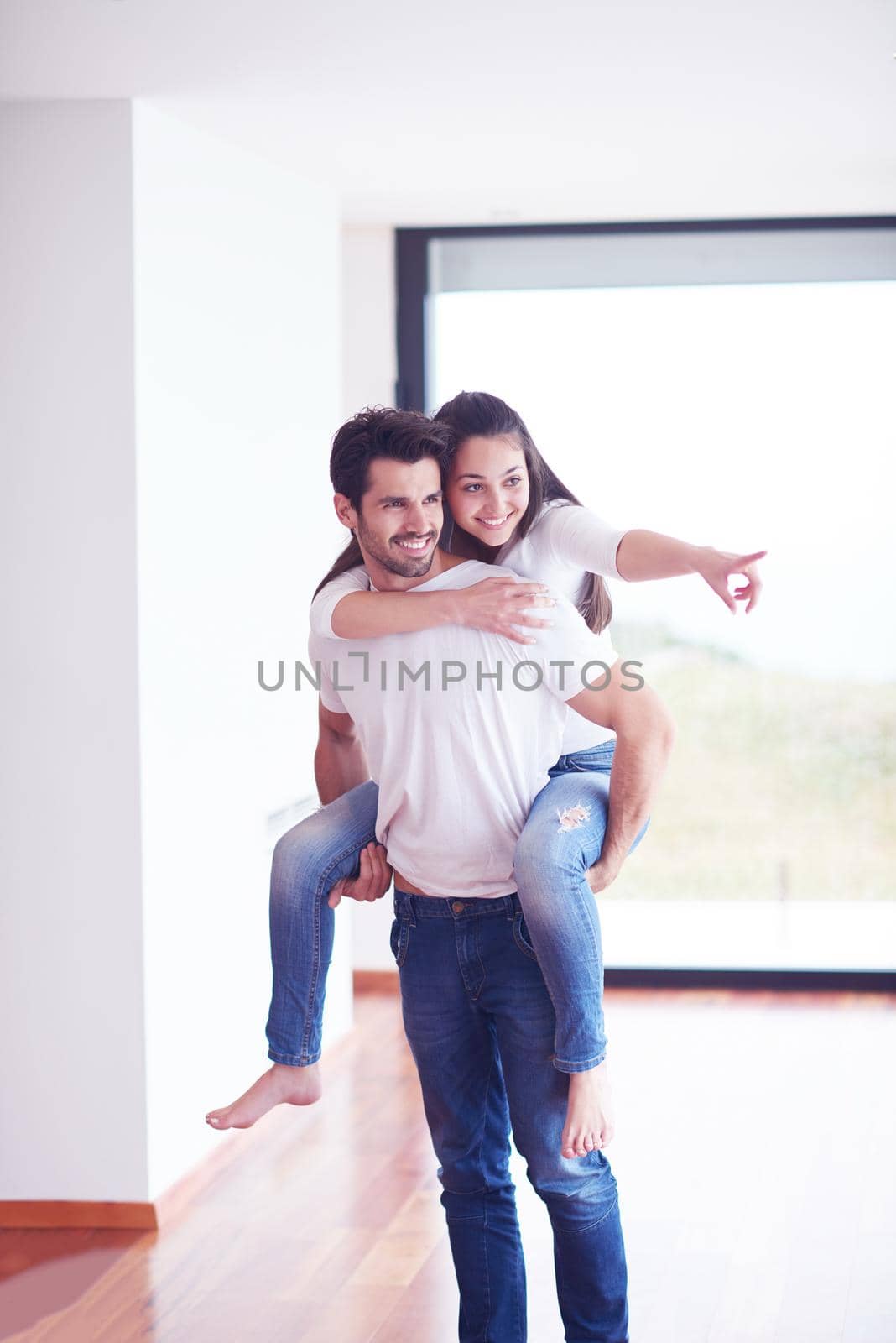 happy young romantic couple have fun and  relax at home by dotshock