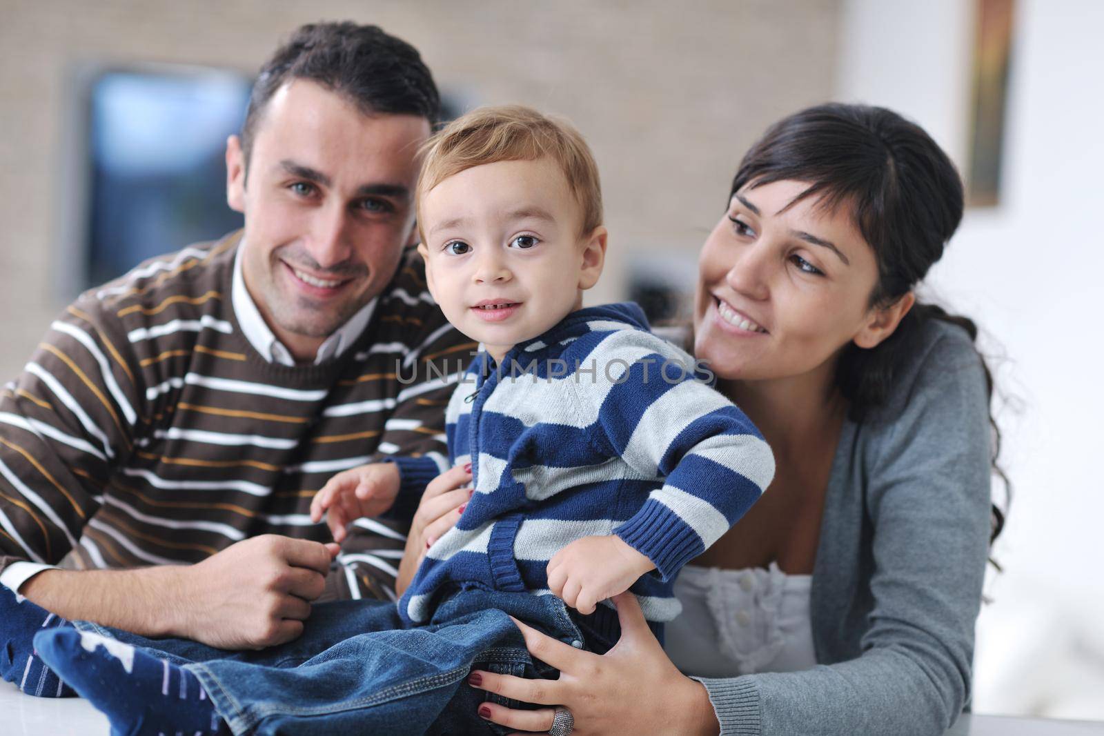 happy young family have fun and relaxing at new home with bright furniture