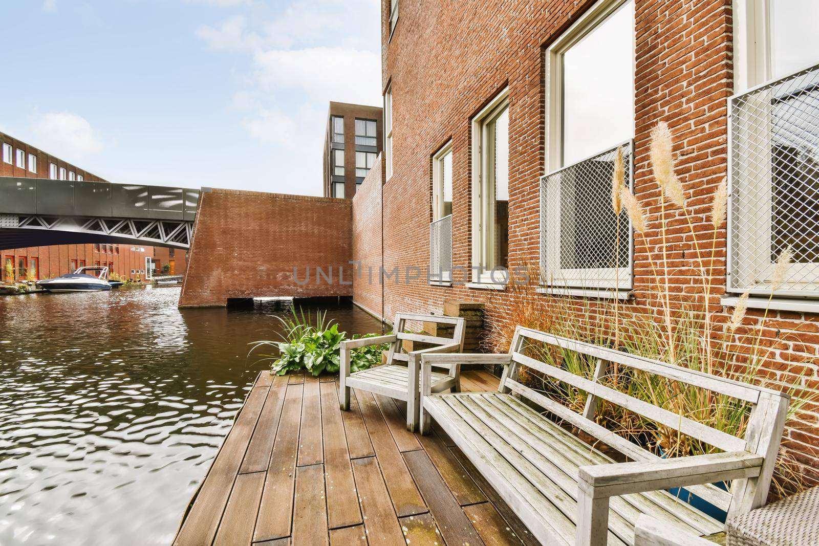 Adorable wooden boathouse in front of brick houses