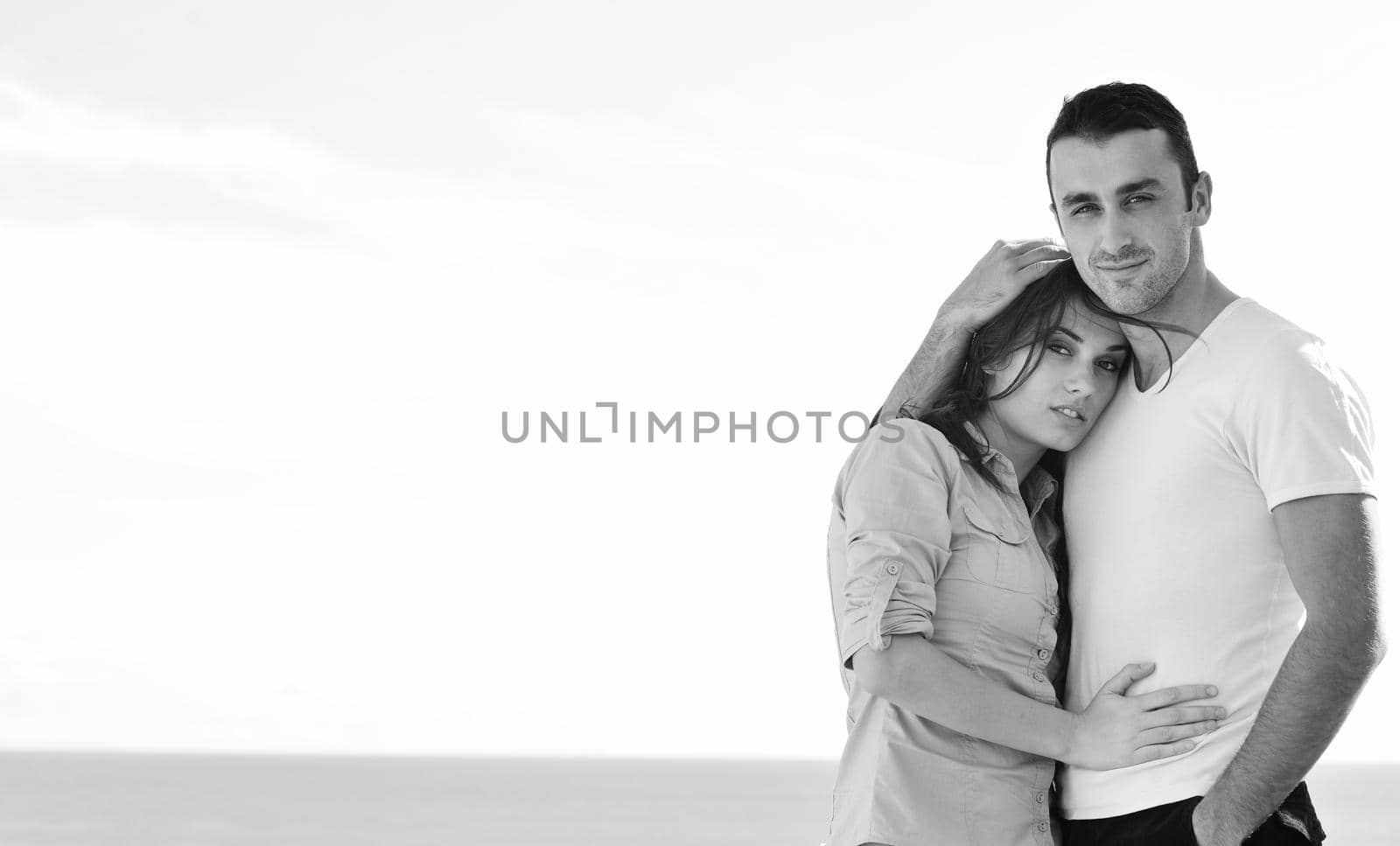 happy young couple in love have romance  relax on balcony outdoor with ocean and blue sky in background