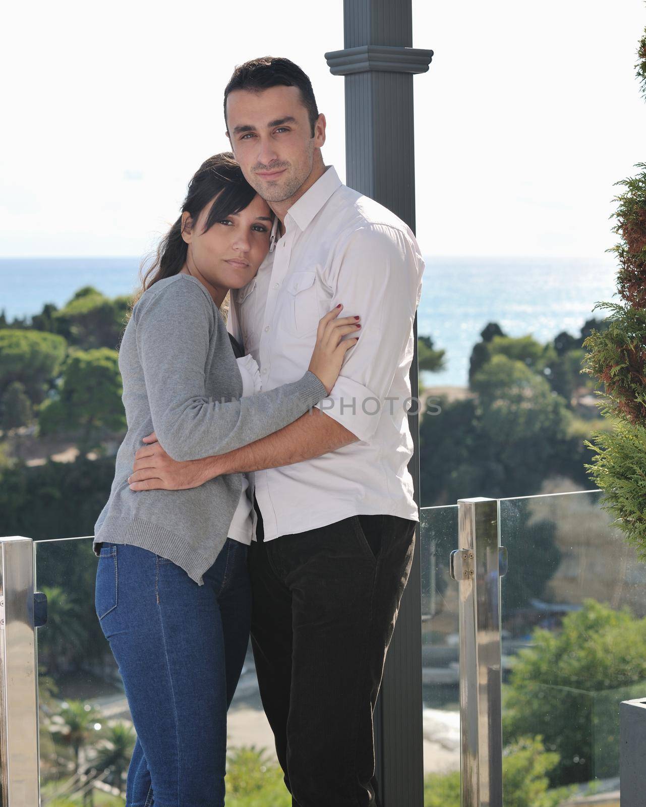 happy young couple in love have romance  relax on balcony outdoor with ocean and blue sky in background