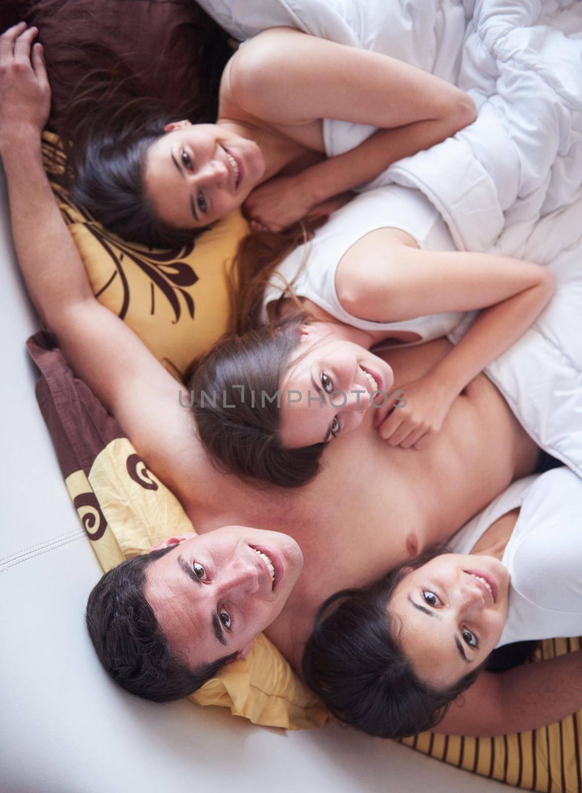 handsome man in bed with three beautiful woman by dotshock