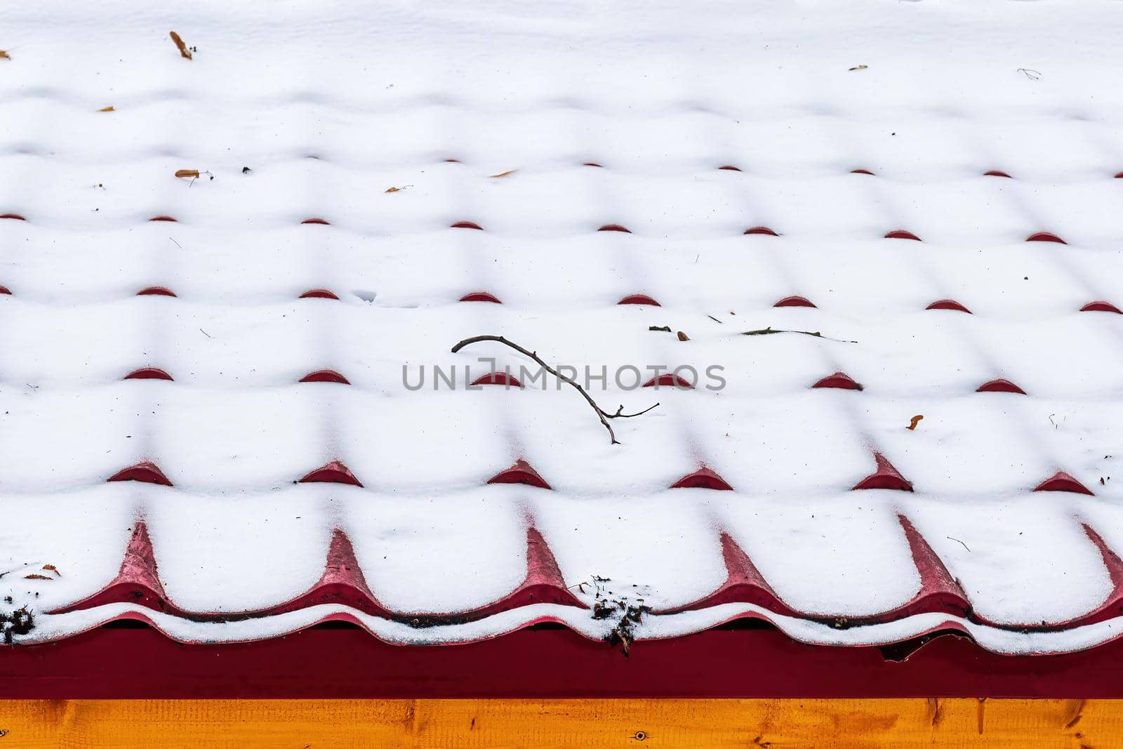 A thin layer of snow on the roof tile. by Eugene_Yemelyanov