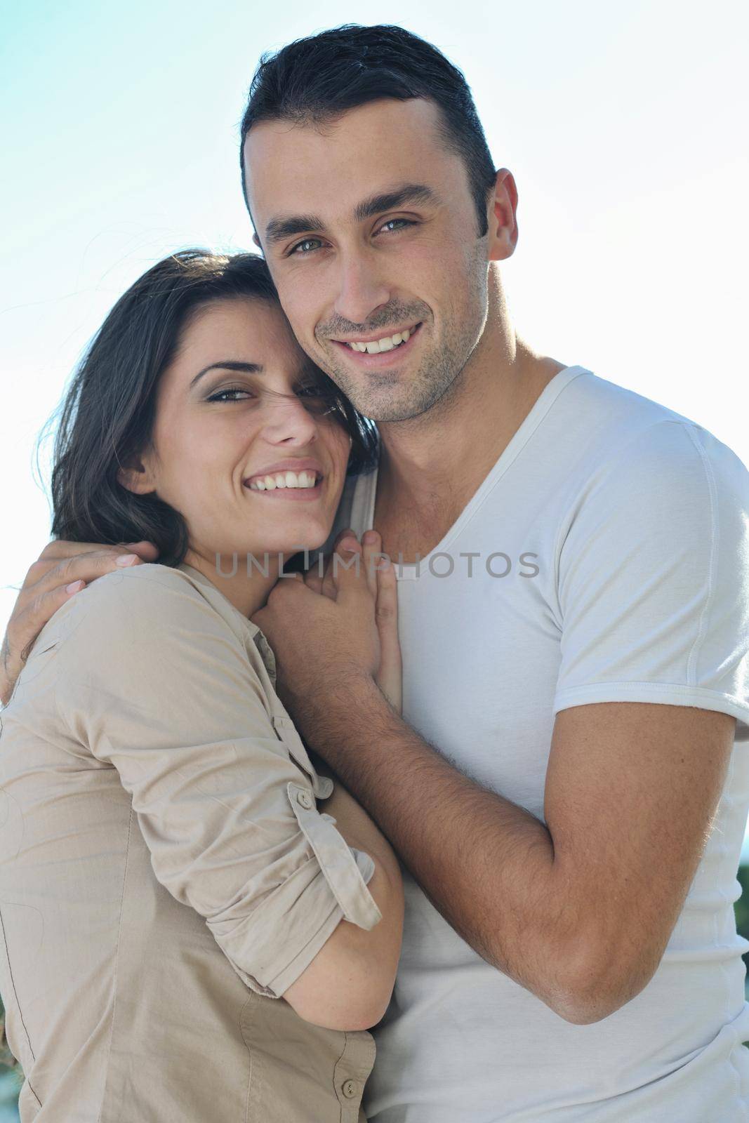 happy young couple in love have romance  relax on balcony outdoor with ocean and blue sky in background