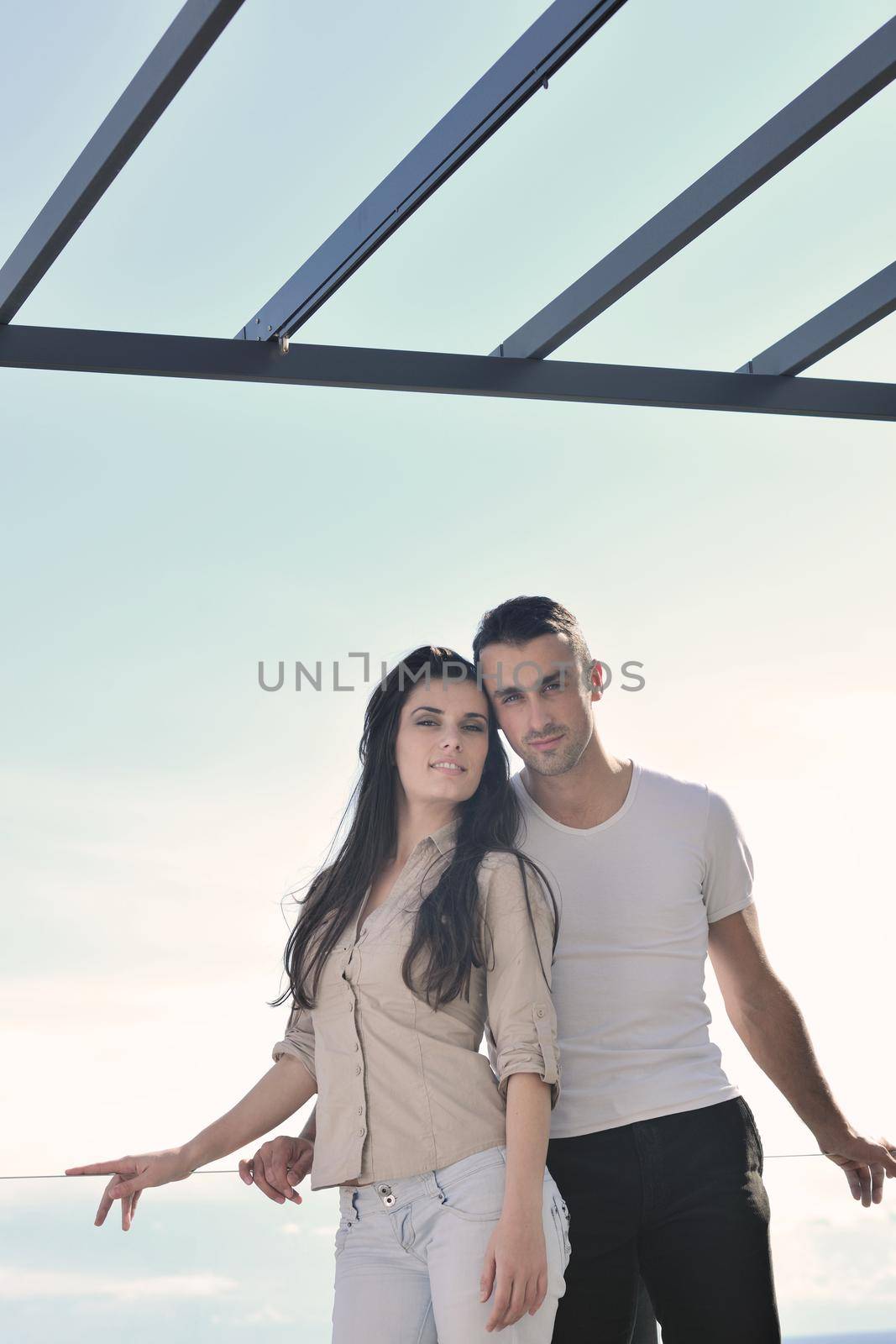 happy young couple in love have romance  relax on balcony outdoor with ocean and blue sky in background