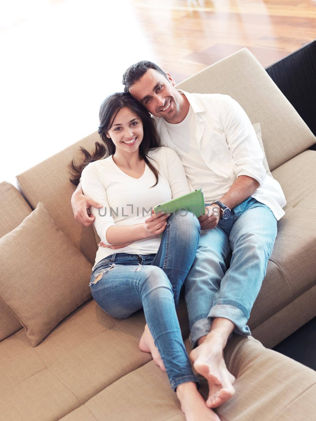 romantic relaxed young couple at modern home using tablet computer