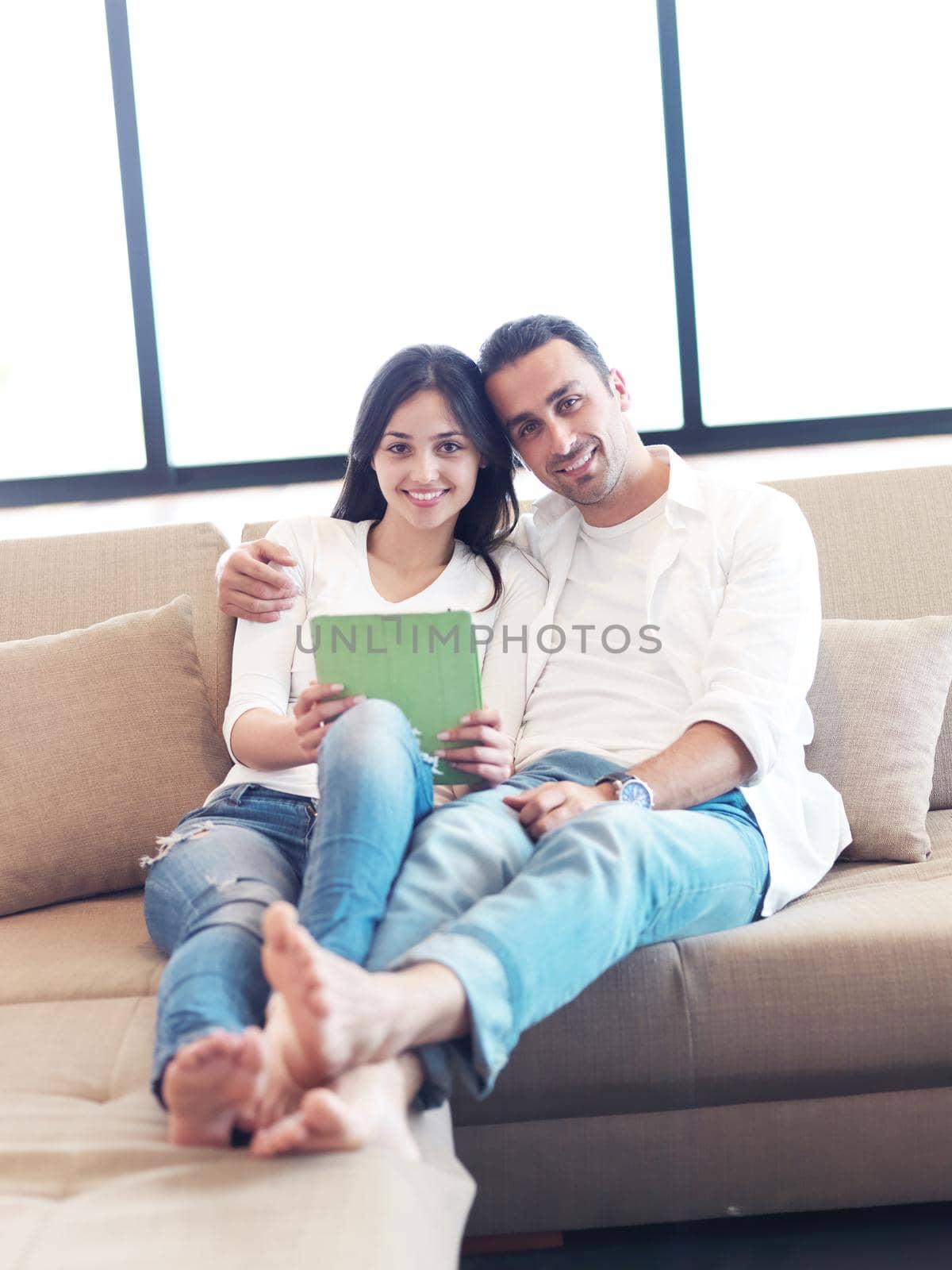 romantic relaxed young couple at modern home using tablet computer