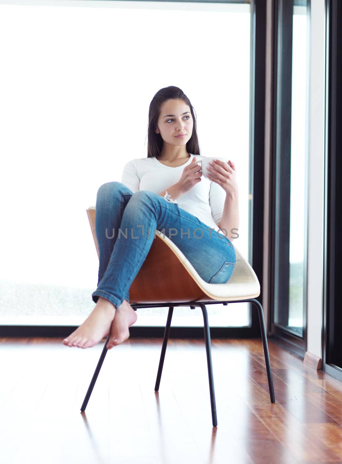 beautiful young woman drink first morning coffee at modern home interior