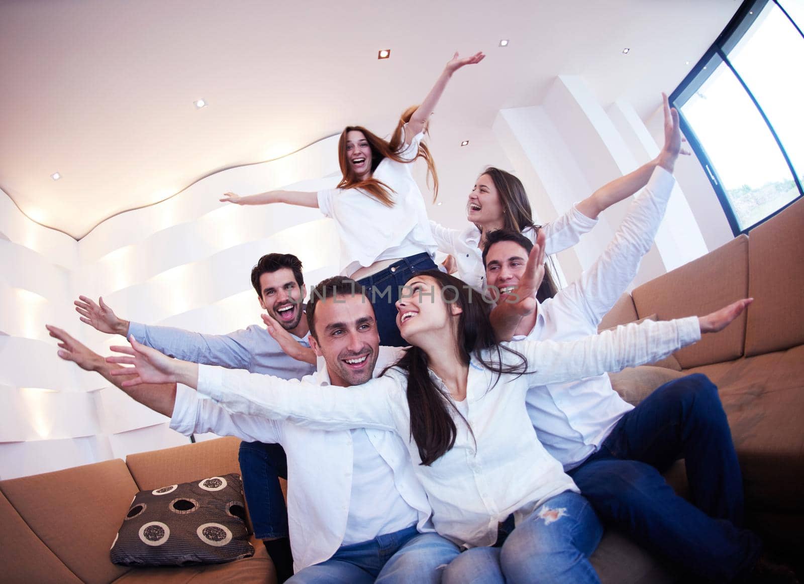 group of friends taking selfie photo with tablet at modern home indoors