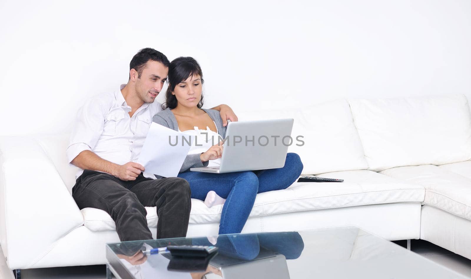 joyful couple relax and work on laptop computer at modern living room indoor home