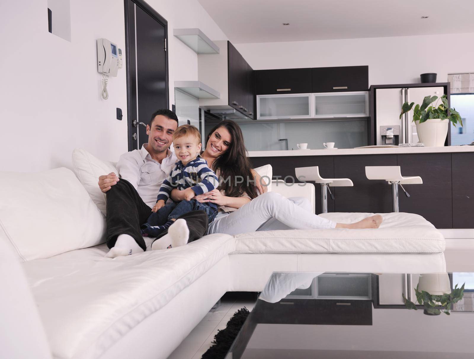 happy young family have fun and relaxing at new home with bright furniture