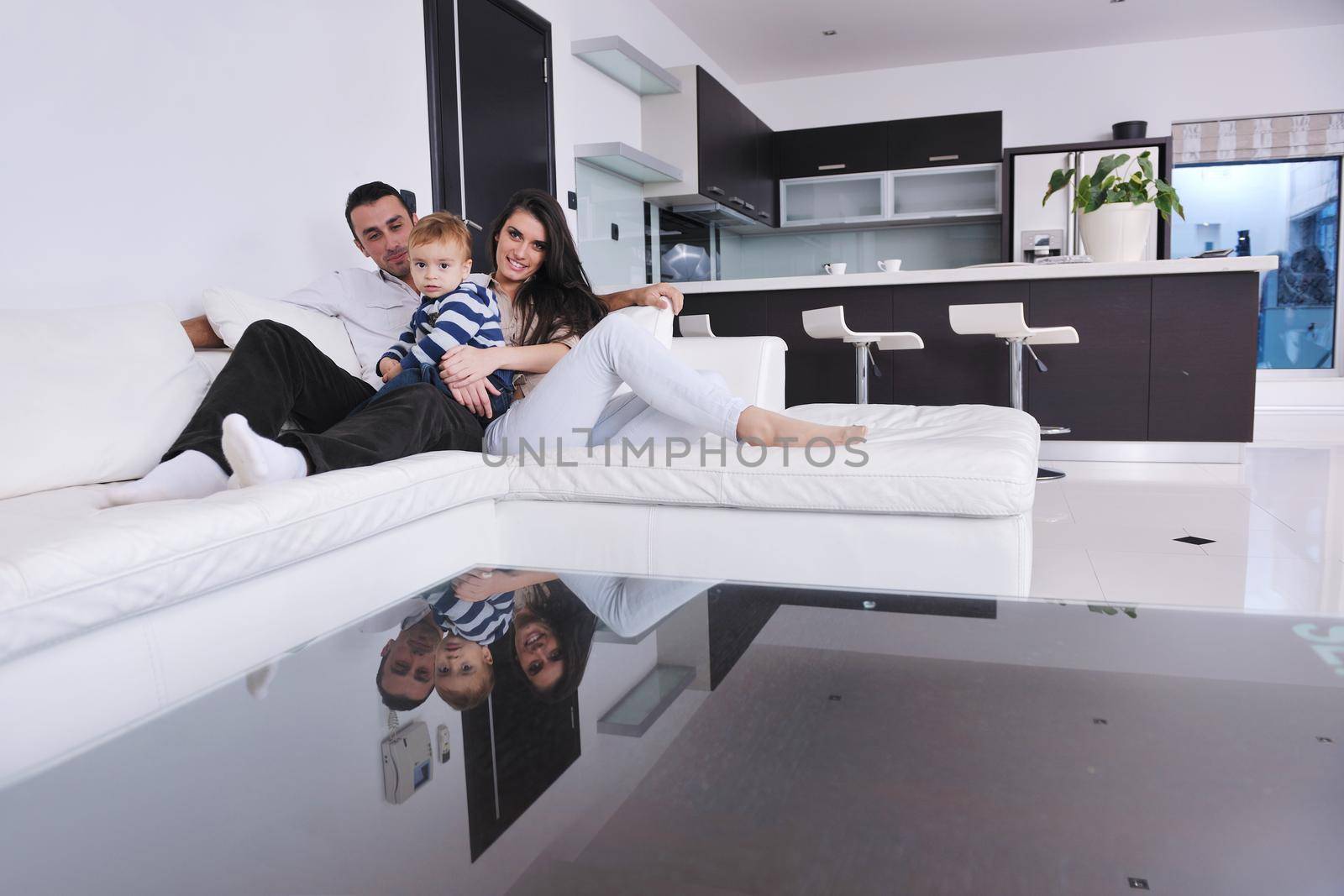 happy young family have fun and relaxing at new home with bright furniture