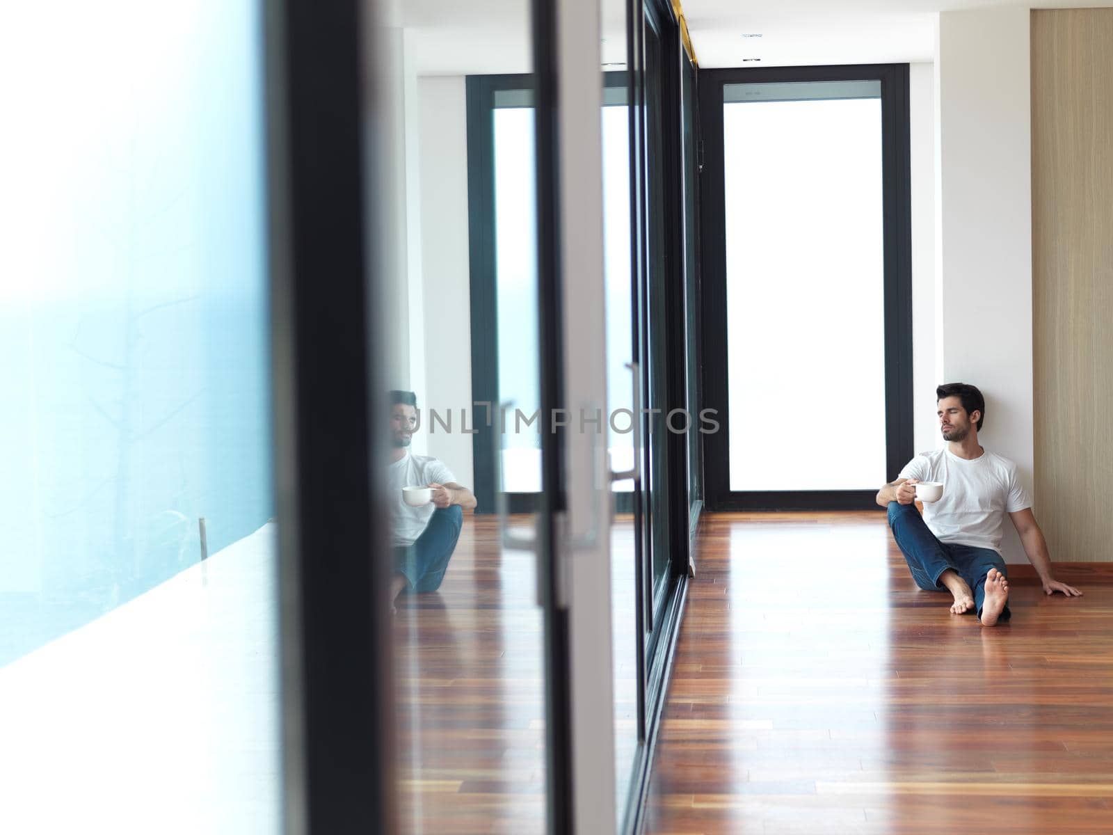 relaxed young man drink first morning coffee at modern home indoors