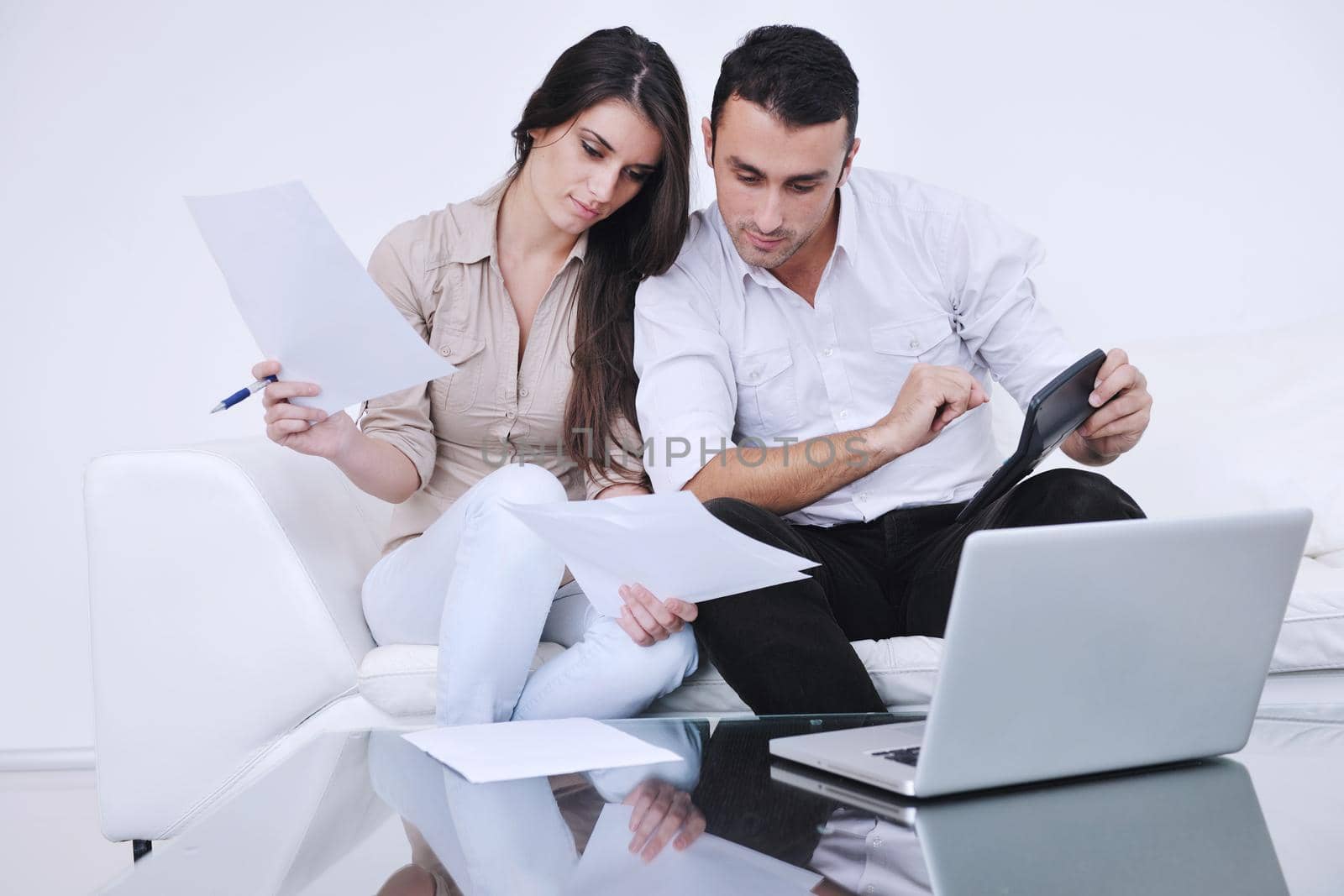 joyful couple relax and work on laptop computer at modern living room indoor home